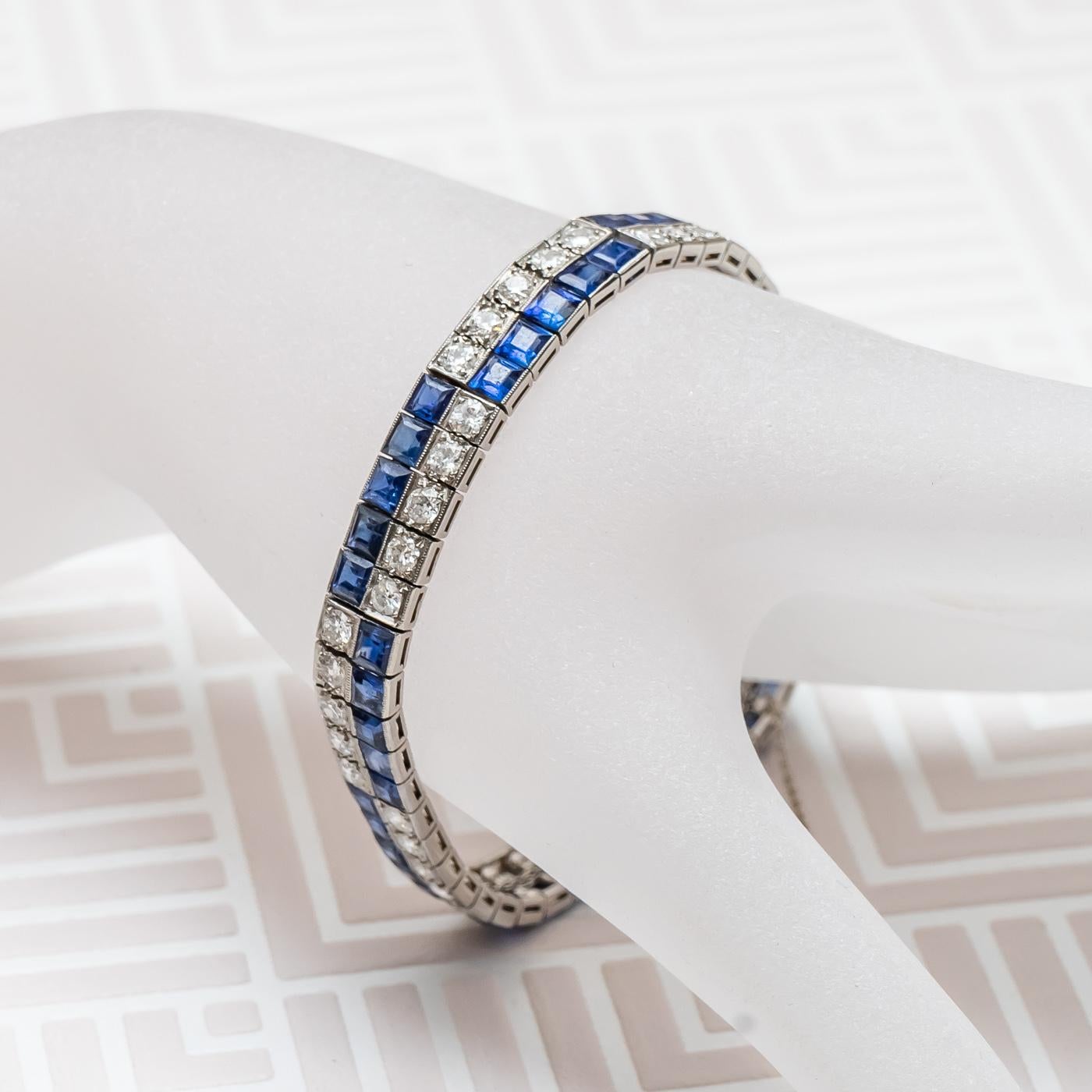 A Chaumet sapphire and diamond bracelet, set with square-cut sapphires and round brilliant-cut diamonds, mounted in platinum, with white gold fittings. 