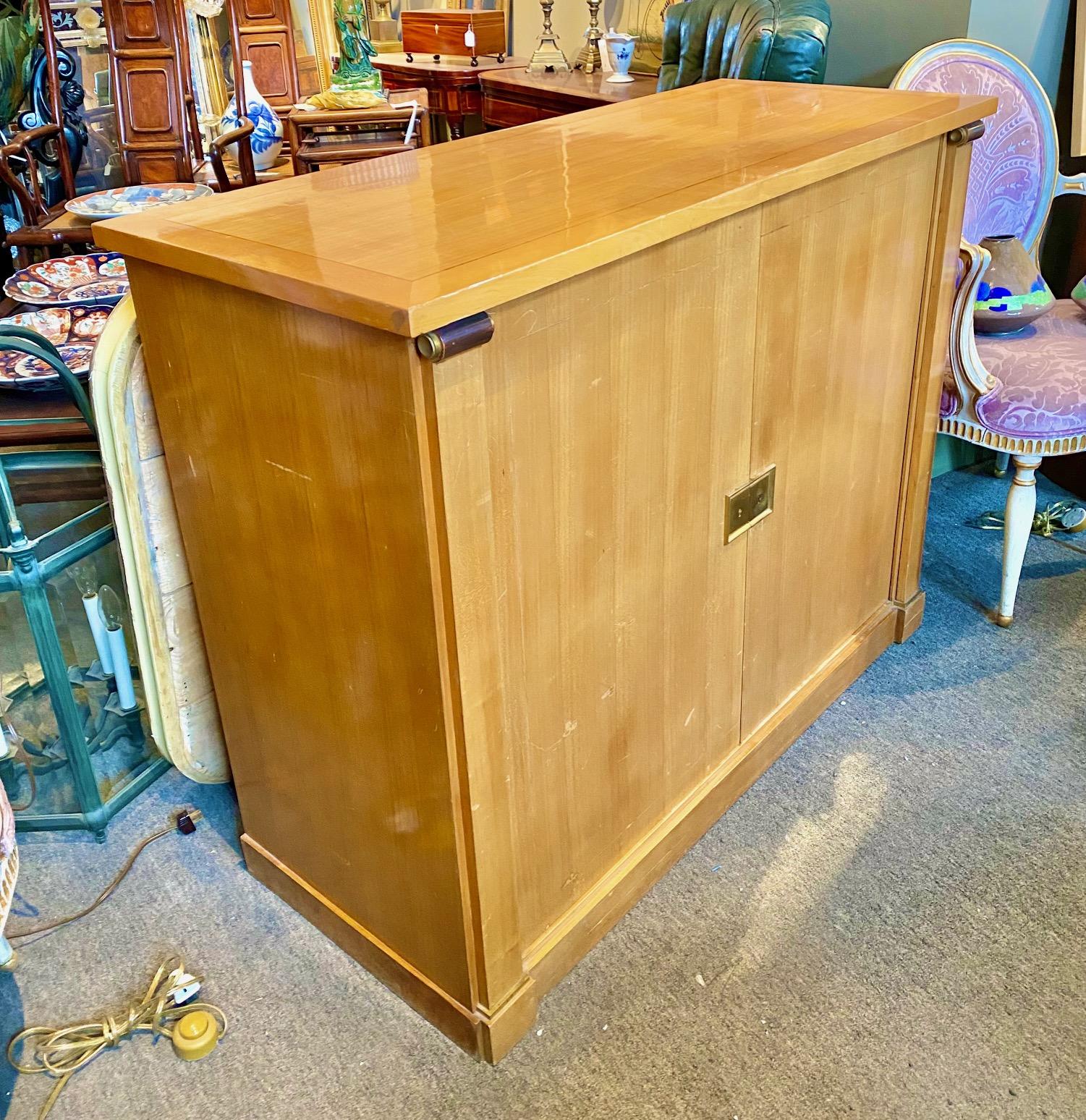 Art Deco classical cherrywood cabinet by Maurice Rinck with two doors revealing a compartmentalized interior in sycamore. Keyhole and finishes in gilded brass.
Stamped 