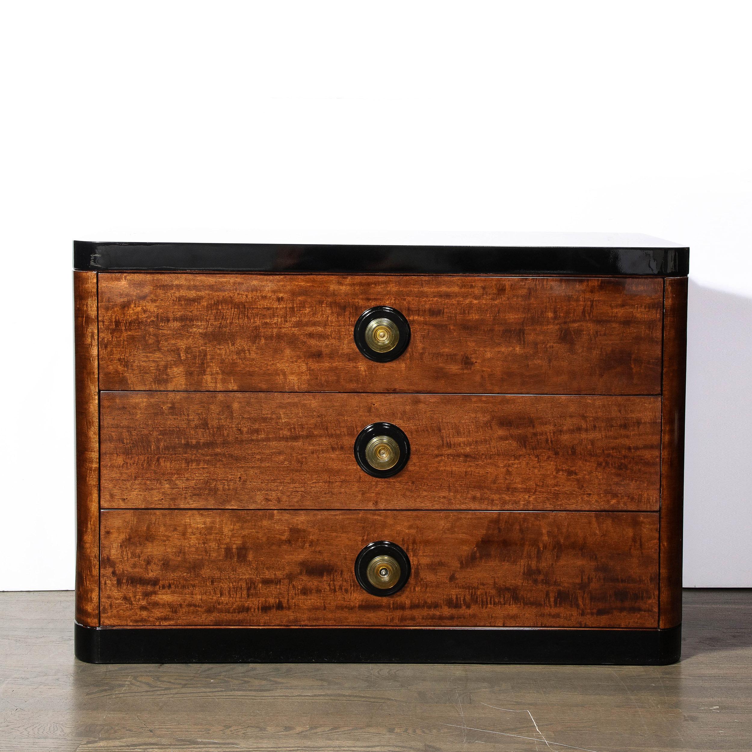 This Art Deco Machine Age  Chest in Book-matched and Burled Walnut with Amber Bakelite Pulls originates from the United States, Circa 1935. Streamlined and utilizing beautiful geometric proportions characteristic of period Art Deco designs, the