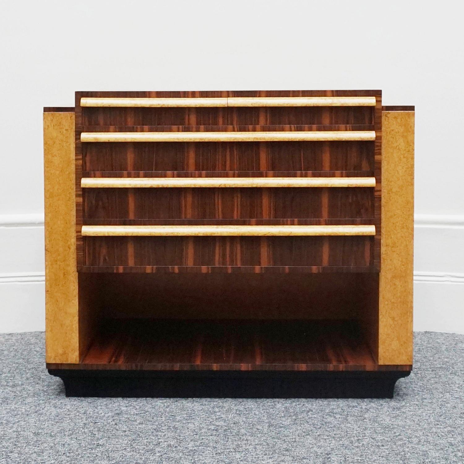 An Art Deco chest of drawers designed by Serge Ivan Chermayeff (1900-1995) for Waring & Gillows. Karelian birch and Macassar ebony veneered. Five upper drawers with a lower open shelf. Waring & Gillows stamp to inside of upper left drawer.