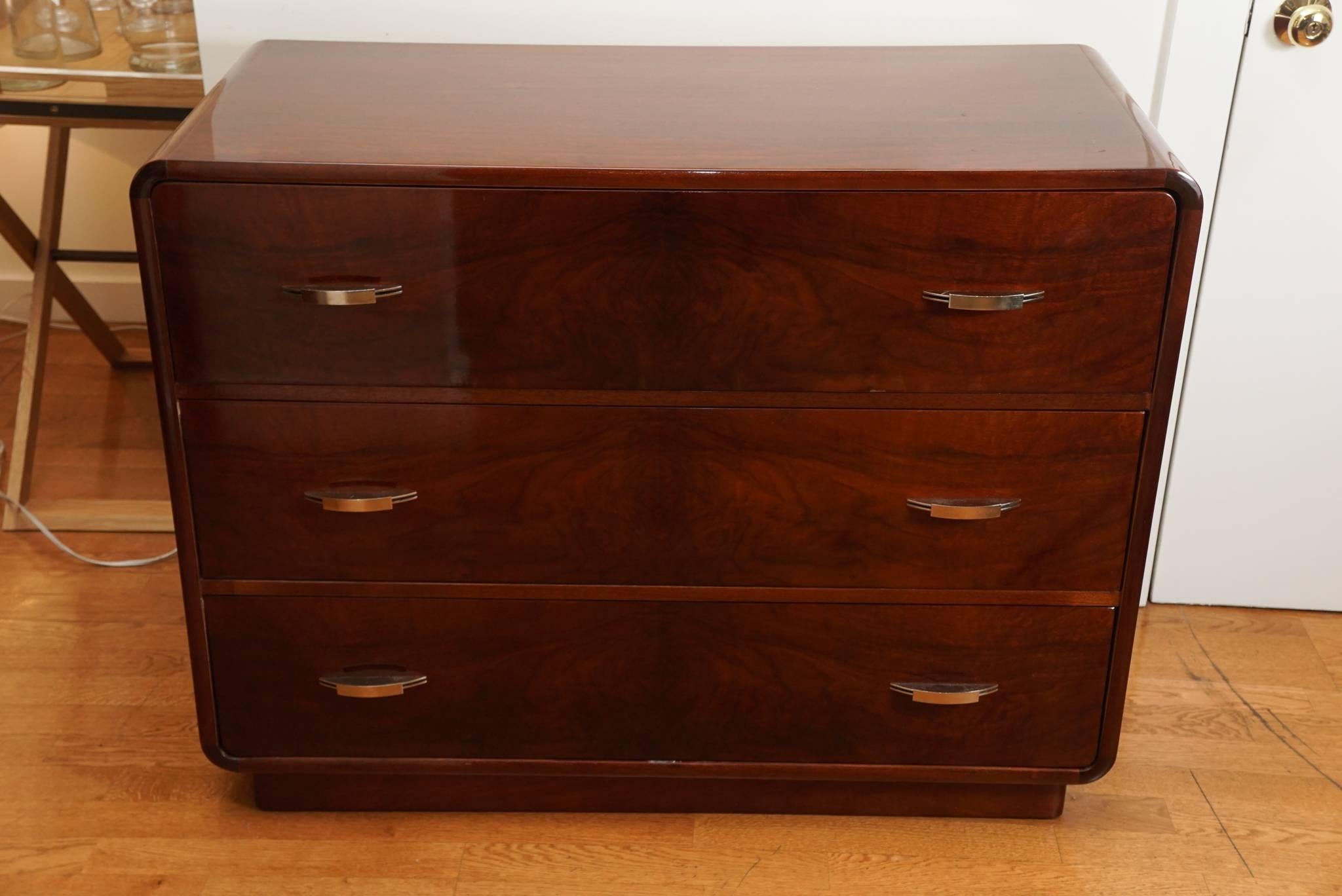 Amazing, Art Deco, two sided chest of drawers, in a glossy mahogany, with elegant design elements that characterized the age. Including rounded corners and brass hardware. A very special piece!