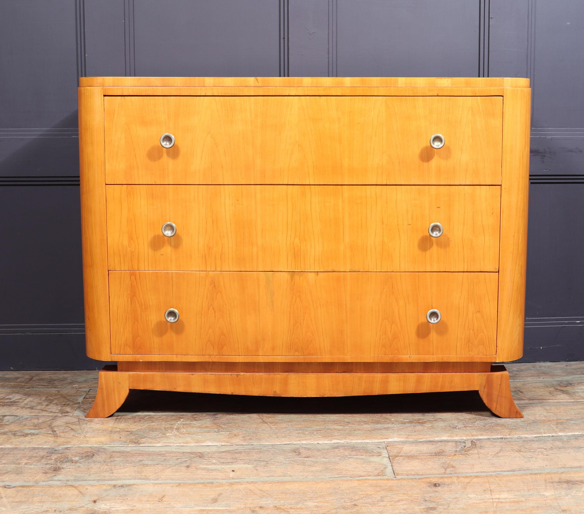 Art Deco chest of drawers.
A French Art Deco chest of drawers produced in cherrywood having three long drawers with brass handles, the chest is wide and slim and stands on a nicely shaped base raised by short sabre feet. The chest has been fully