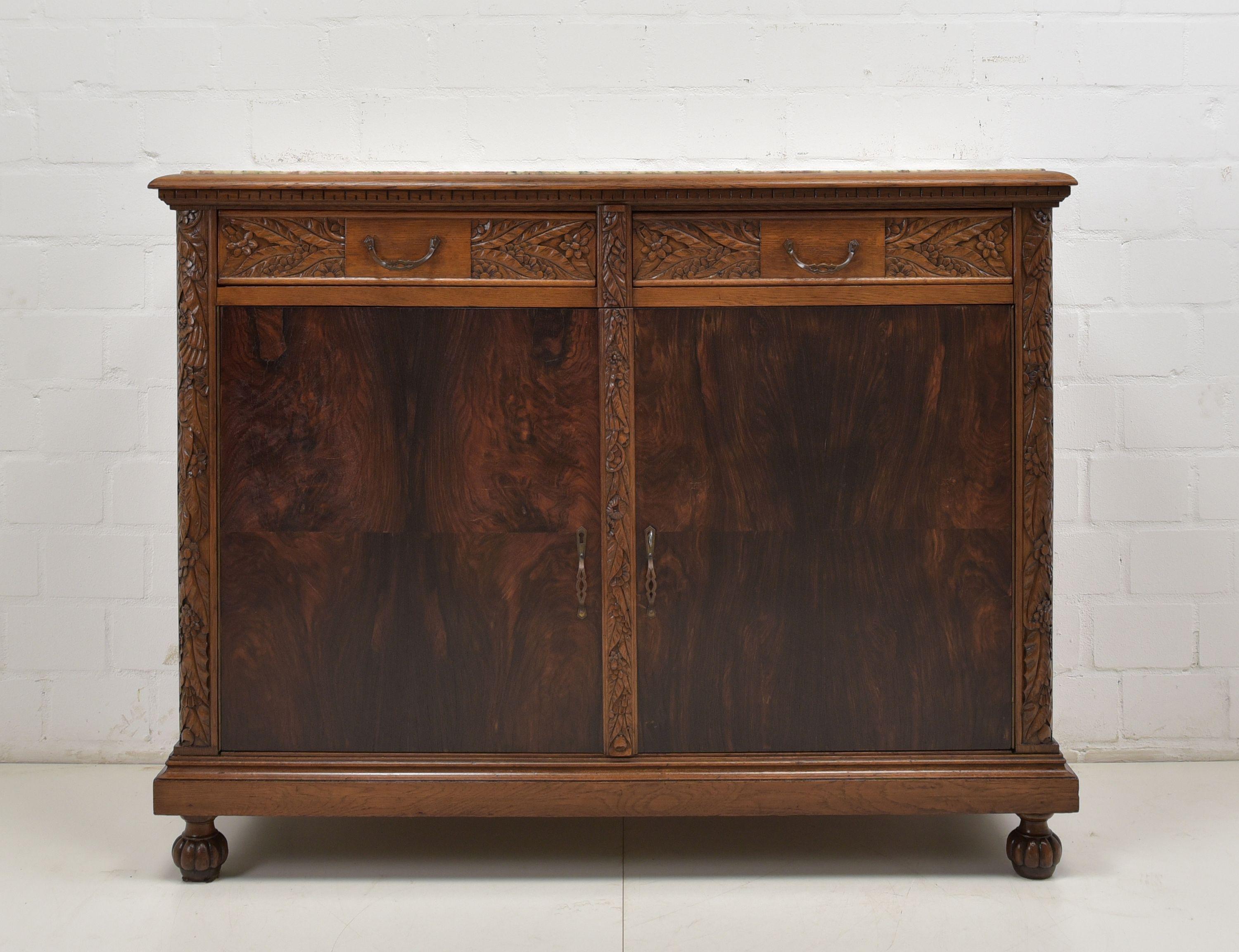 Sideboard restored Art Deco circa 1930 oak rosewood chest of drawers

Features:
Two-door model with 2 drawers and marble top
Solid oak shelf
High quality
Drawers pronged
Original stone slab, was once broken
Original fittings
Abstract