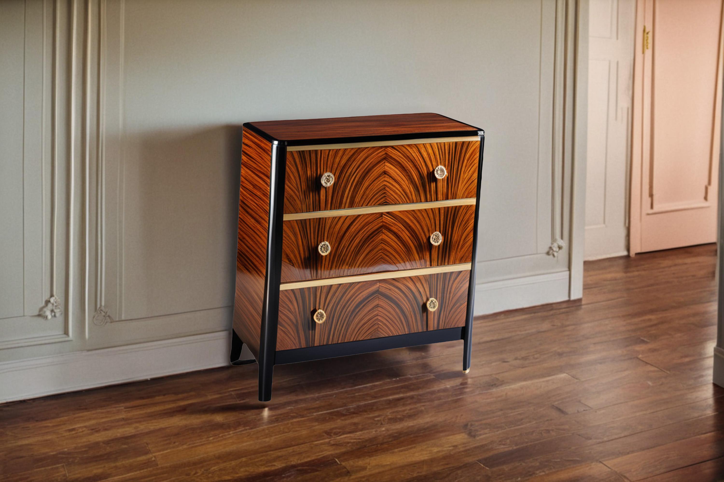 Beautiful little chest of drawers with very elegant macassar veneer and brass handles. The chest of drawers has three drawers and is equipped with round brass handles. The surface was sealed with a high-gloss varnish. The black surface was painted