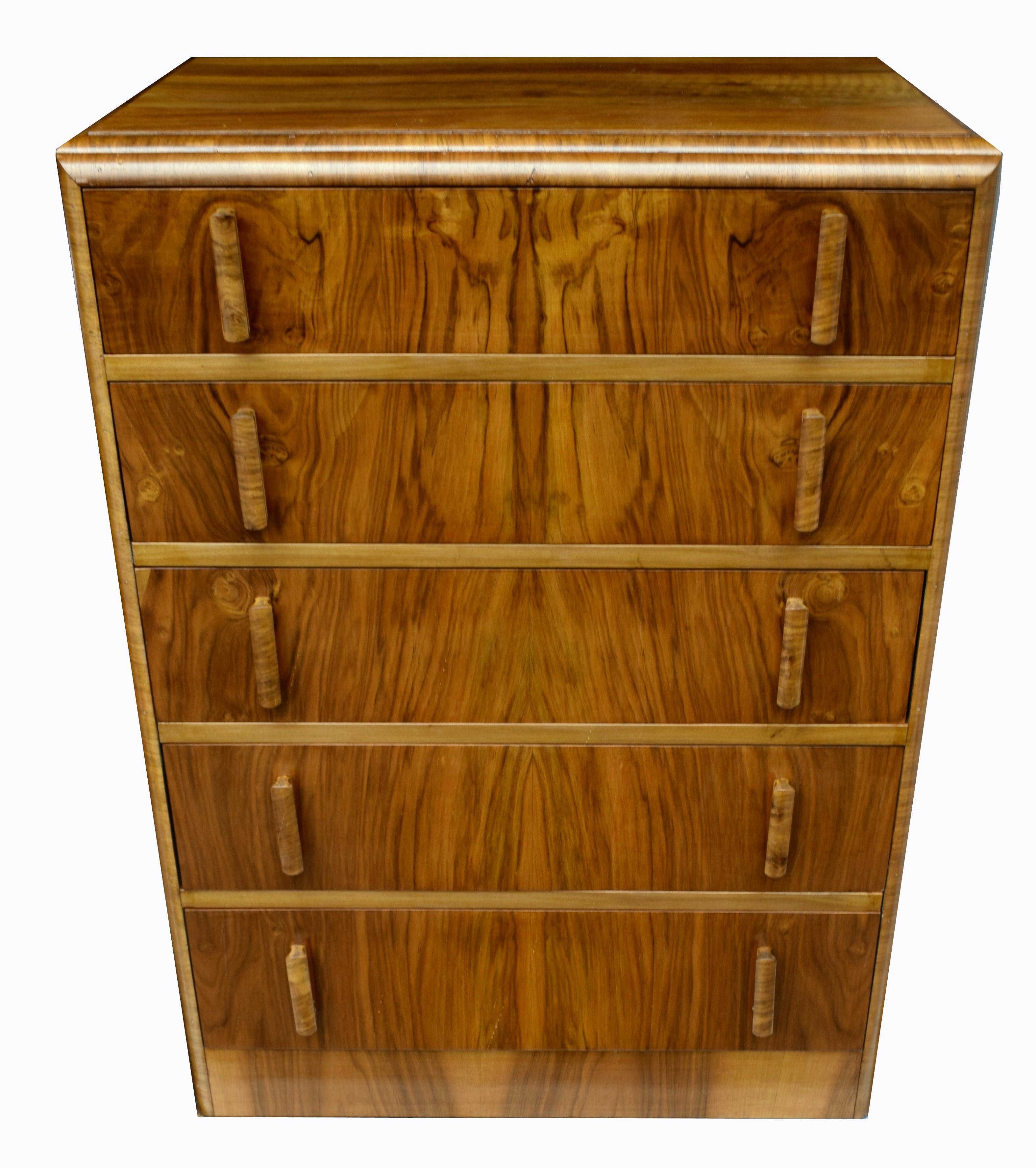 For your consideration is this extremely stylish and original Art Deco chest of drawers which dates to early 1930s and originates from England. Five very generously sized drawers which are veneered in book paged walnut figured veneers. Each drawer