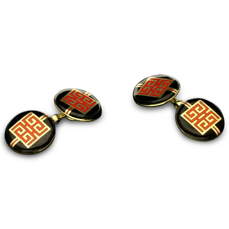 A pair of elegant Art Deco Chinese dragon gold and enamel cufflinks by Cartier c.1930s, the double ended chain link cufflinks finely crafted in 14ct yellow gold with each matching face decorated with a geometric motif in red enamel depicting the