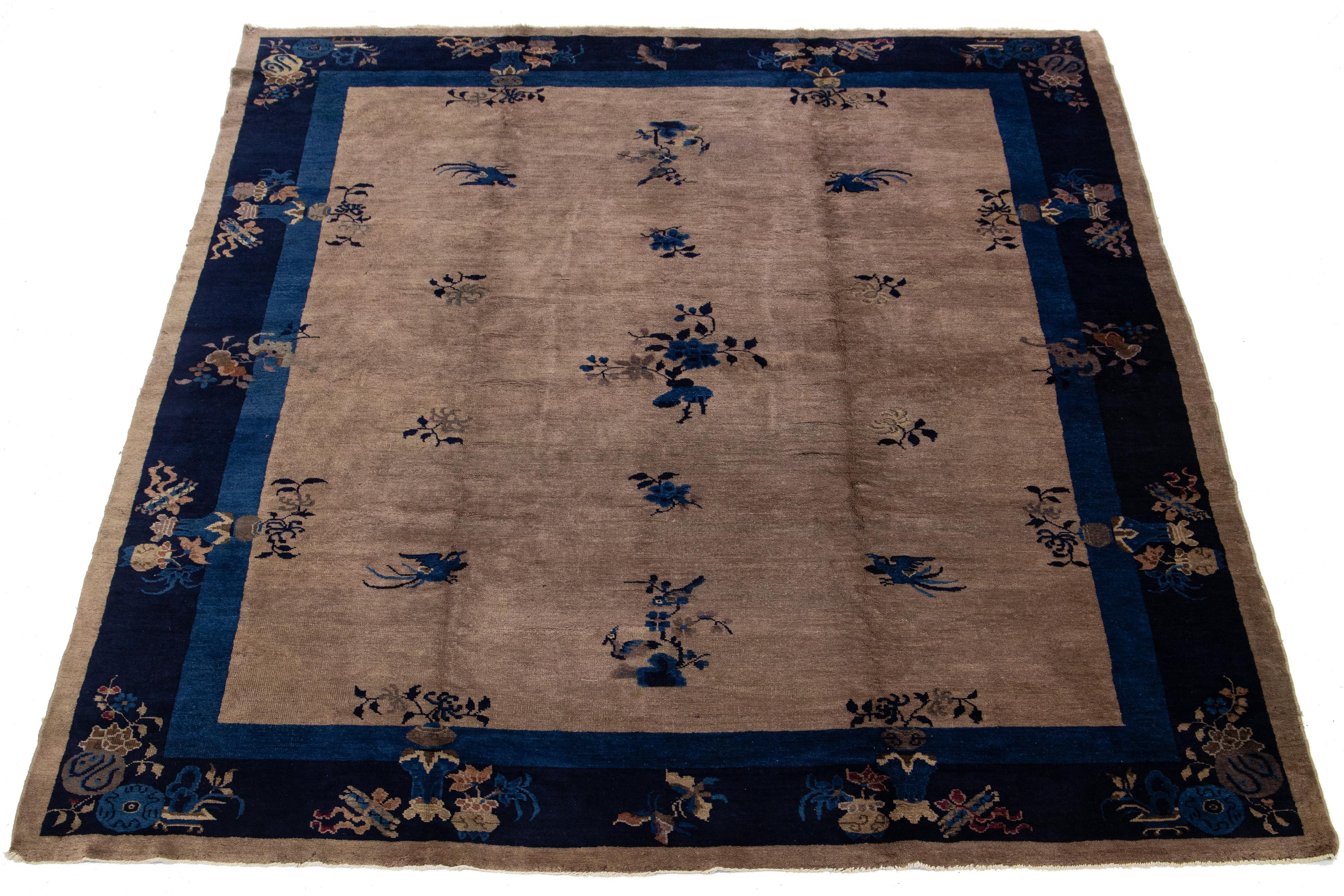 This hand-knotted wool Antique Chinese Art Deco rug features a floral design with black hues on a brown background and a navy blue frame.


This rug measures 8' x 9'7