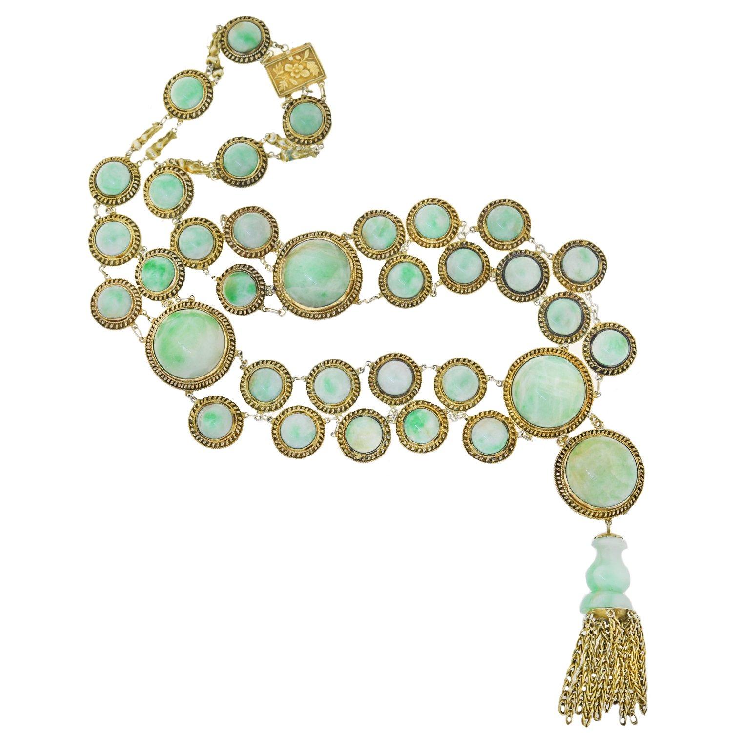 A stunning jade necklace from the Art Deco (ca1920s) era! This beautiful and bold piece is crafted in gilded sterling silver and comprised of incredible jade cabochon links that rest dramatically along the neckline. A wonderful reflection of its