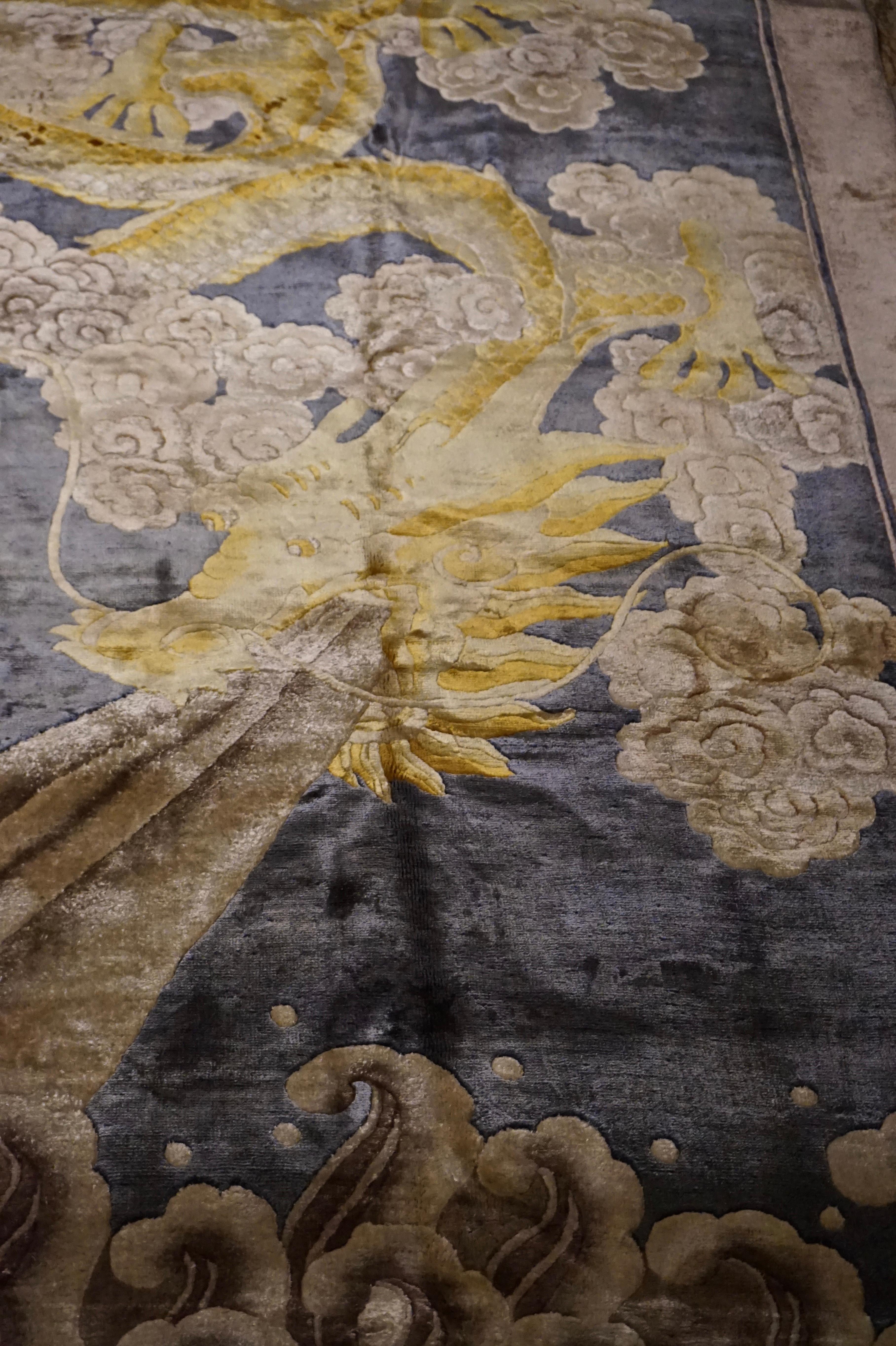 Conversation piece Art Deco Chinese hand knotted fine silk rug depicting a fire breathing dragon on waves in dramatic form. Work of art in silk and not to be seen again! Condition excellent save for minor circular stain on bottom right border