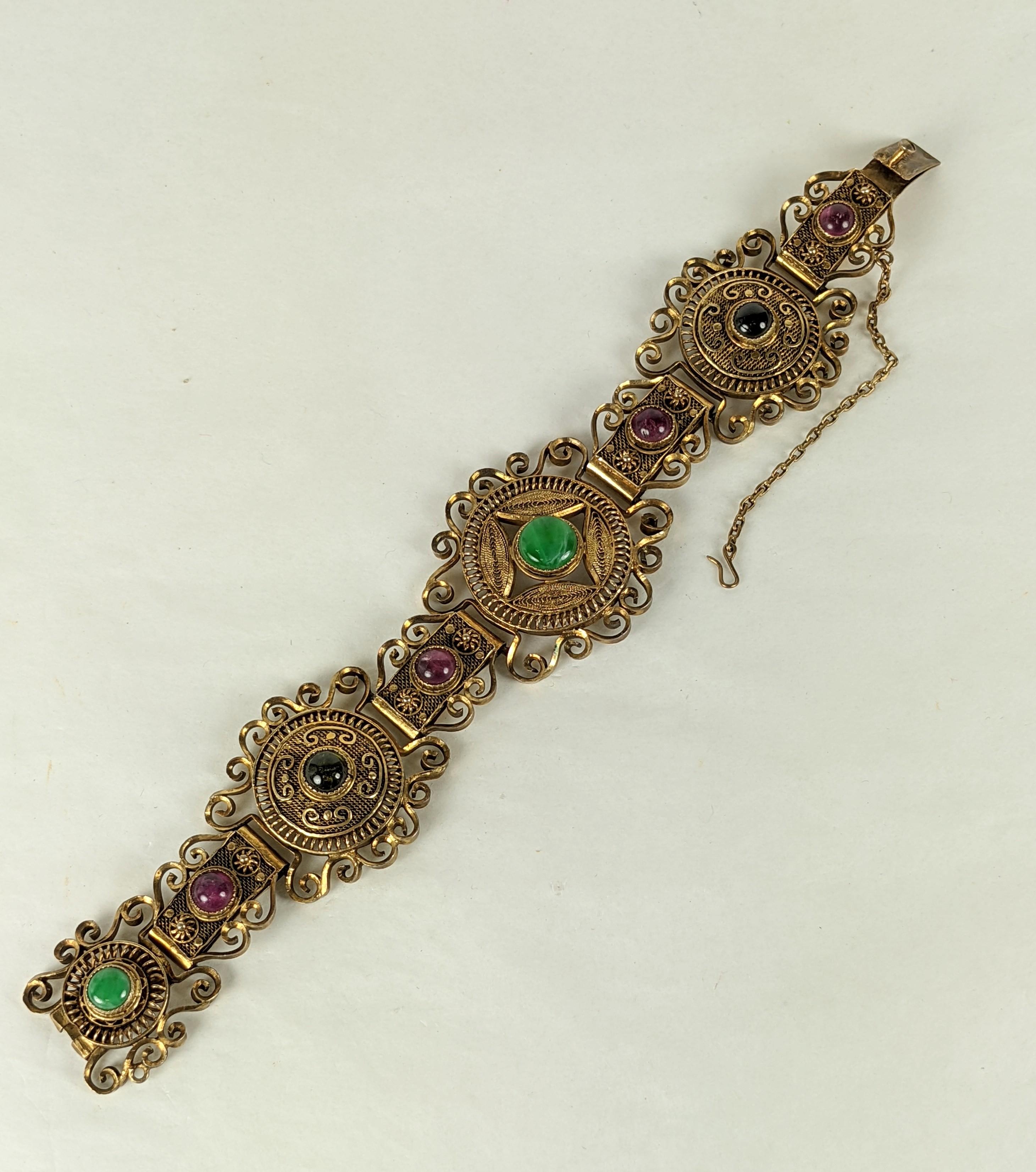 Lovely Chinese Silver Vermeil Bracelet with Gemstones cabochons in pink and green tourmalines with jade. Bracelet is widest at center with 3 central round motifs, all decorated with ornate hand made filigree work.  Measures 7