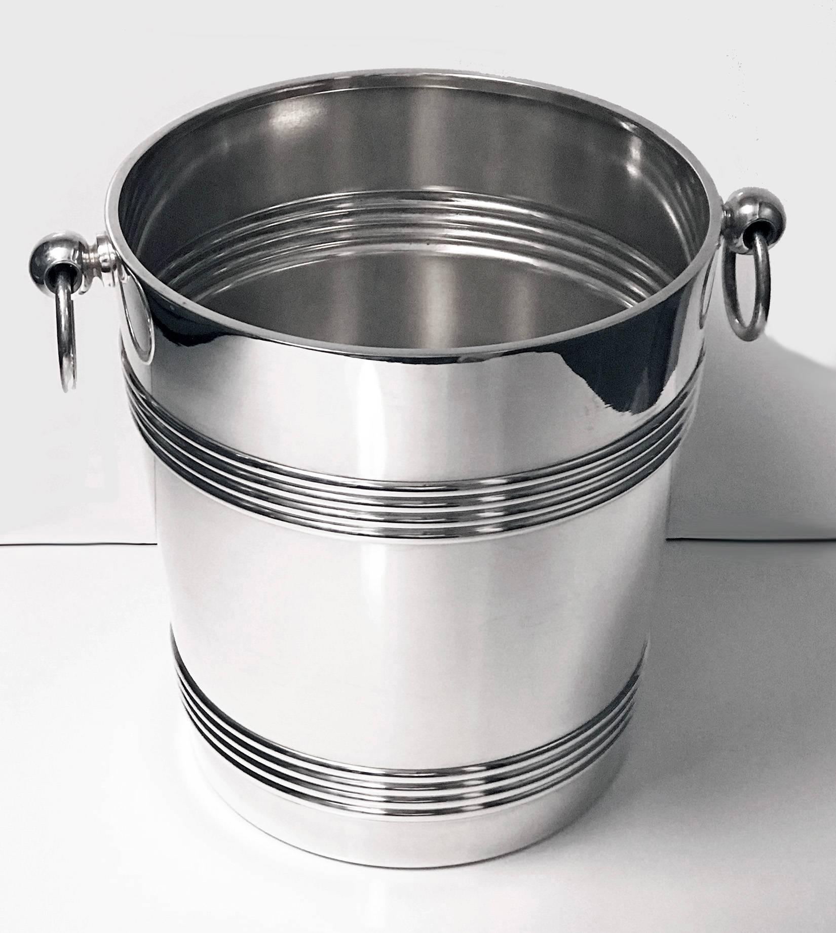 Art Deco Christofle silver plate cooler, France, circa 1935. The cooler of large very slightly tapered form, plain with upper and lower reeded band surround, ring loop handles. Marked with Christofle marks on base. Measures: Height 8 .25 inches.