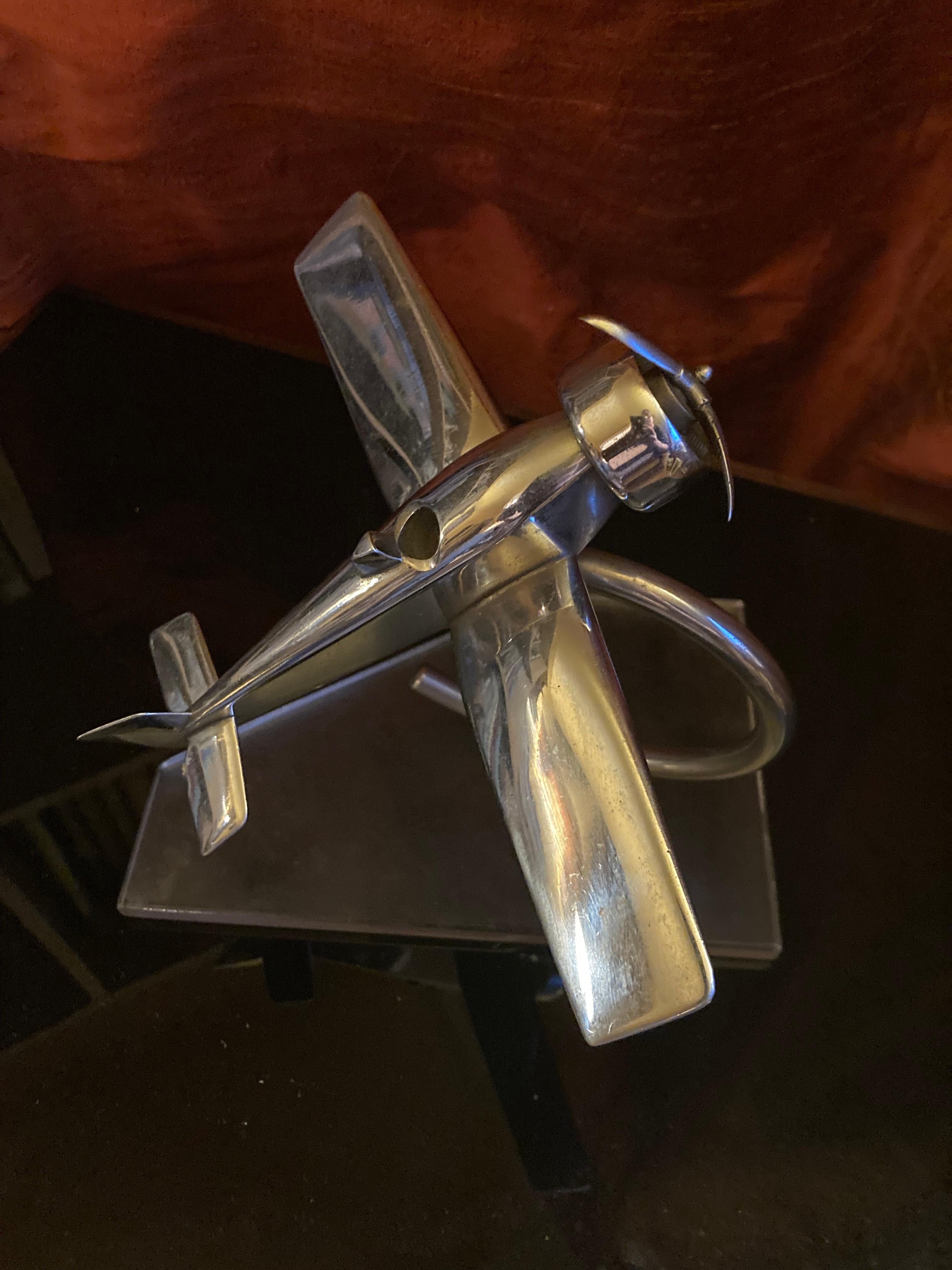 Decorative Art Deco chrome airplane on plastic base. Desk decoration. Probably Germany or France of the thirties. The plastic plate is also from the time. Good general condition with very slight signs of use commensurate with age. The front