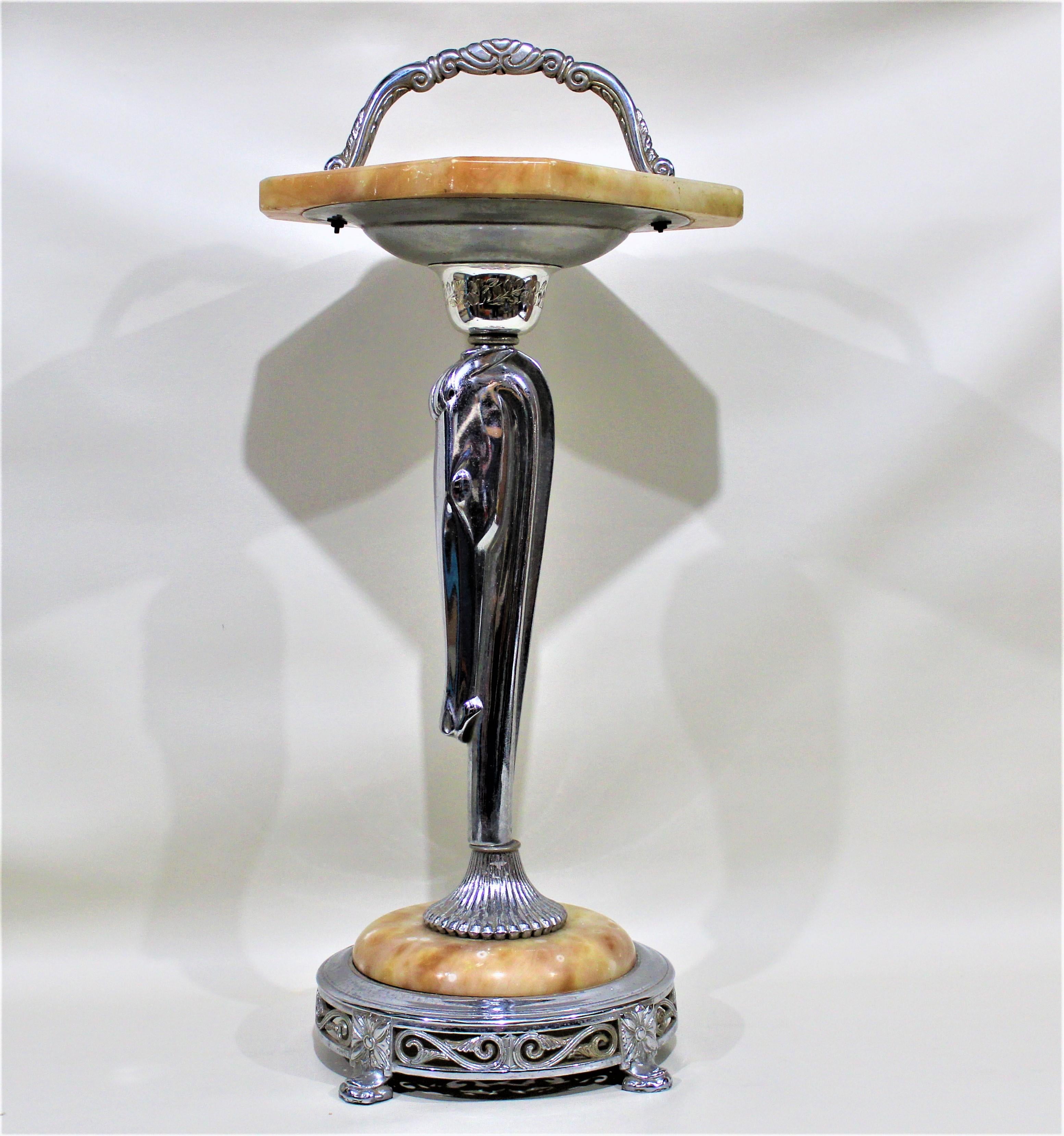 Dating from the mid-20th century, and done in an Art Deco style, this chrome and alabaster smoking Stand or accent table features a stylized figural chrome horse head which constitutes the table's leg that supports an alabaster swivel top with a