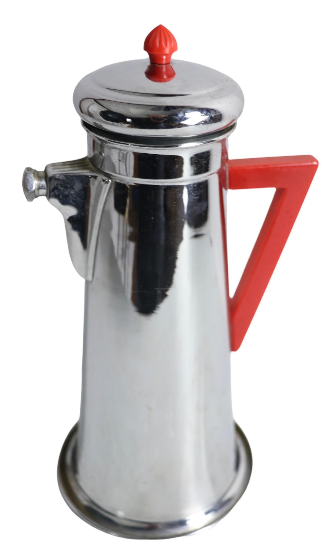 Classic Art Deco Machine Age chrome cocktail shaker, by Forman Brothers. The Shaker features dramatic angular handle of red bakelite, and cocktail recipes impressed on the bottom. This example is in very good, clean original condition, ready to