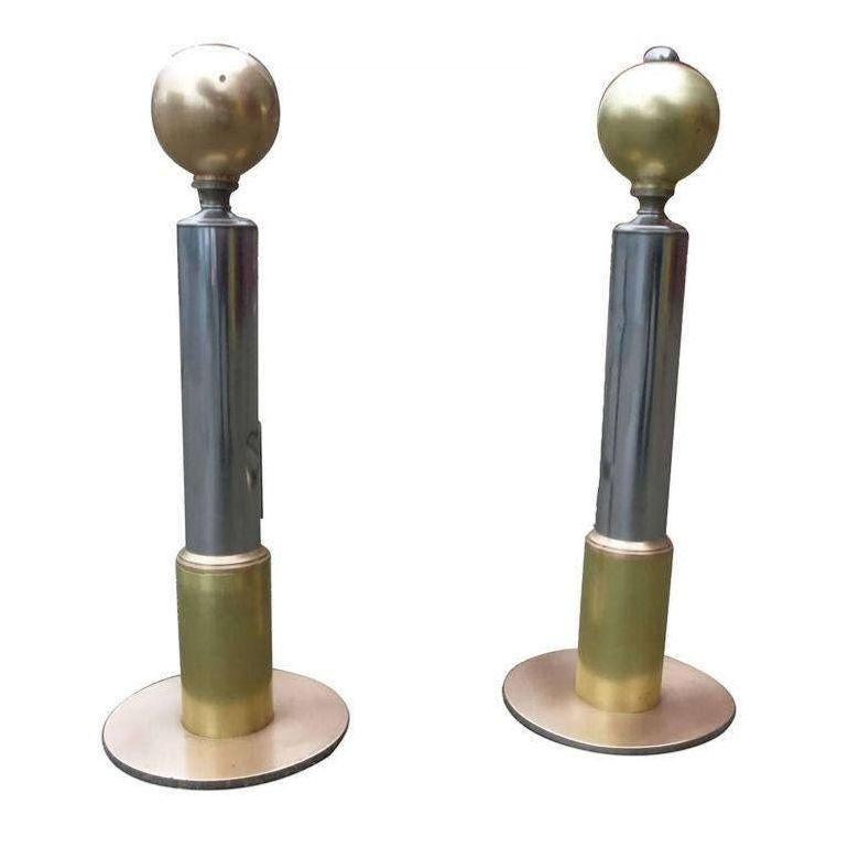 This American Art Deco chrome and brass andirons set that has been restored to its original shine. The andirons feature a 5