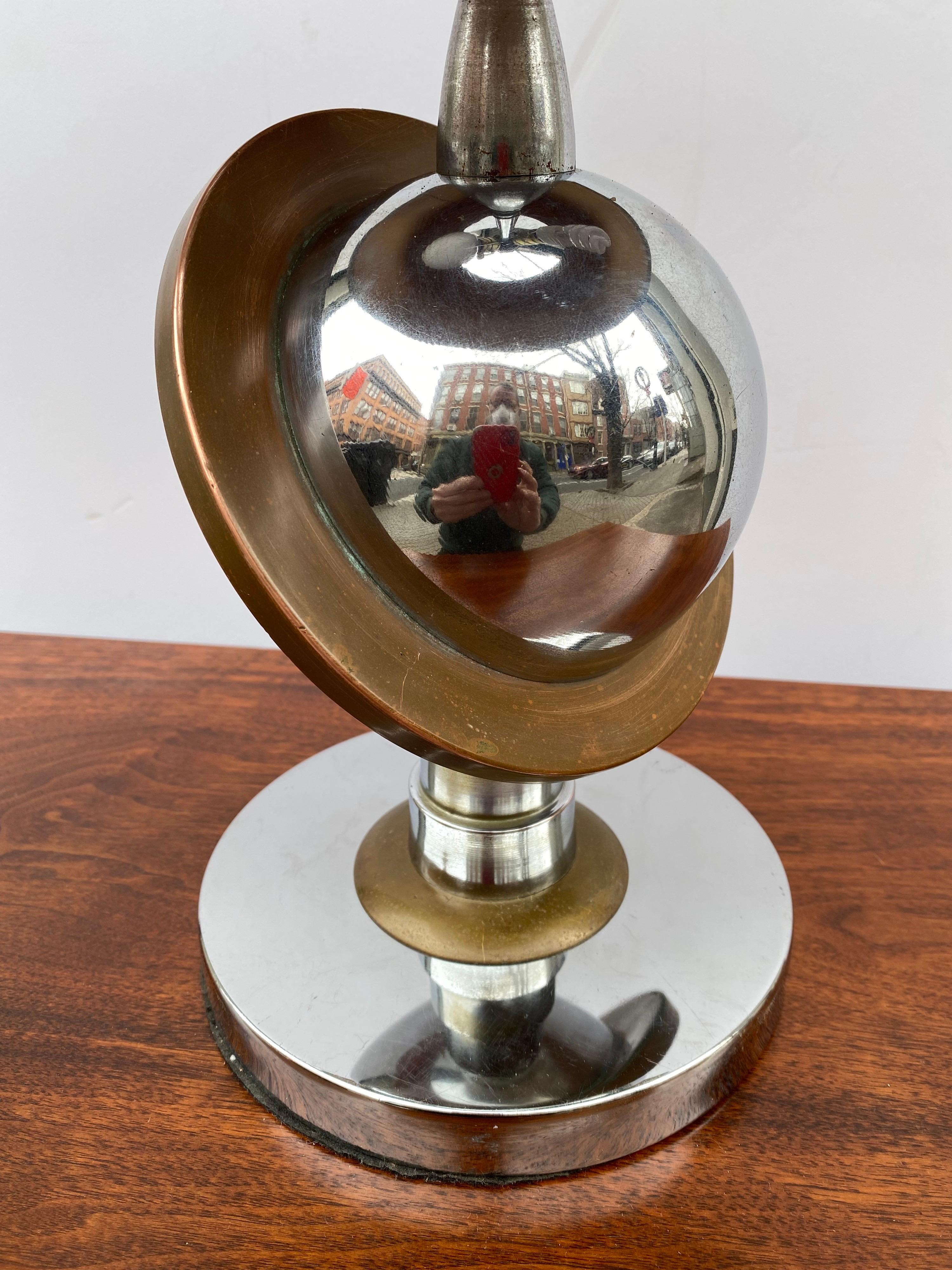 Art Deco saturn chrome and brass table lamp. Saturn was used as a design element in the Chicago 1934 Exhibition and afterwards many designs were created with Saturn imagery. Nice very original Lamp with a Great Shade! Possibly the Original shade but