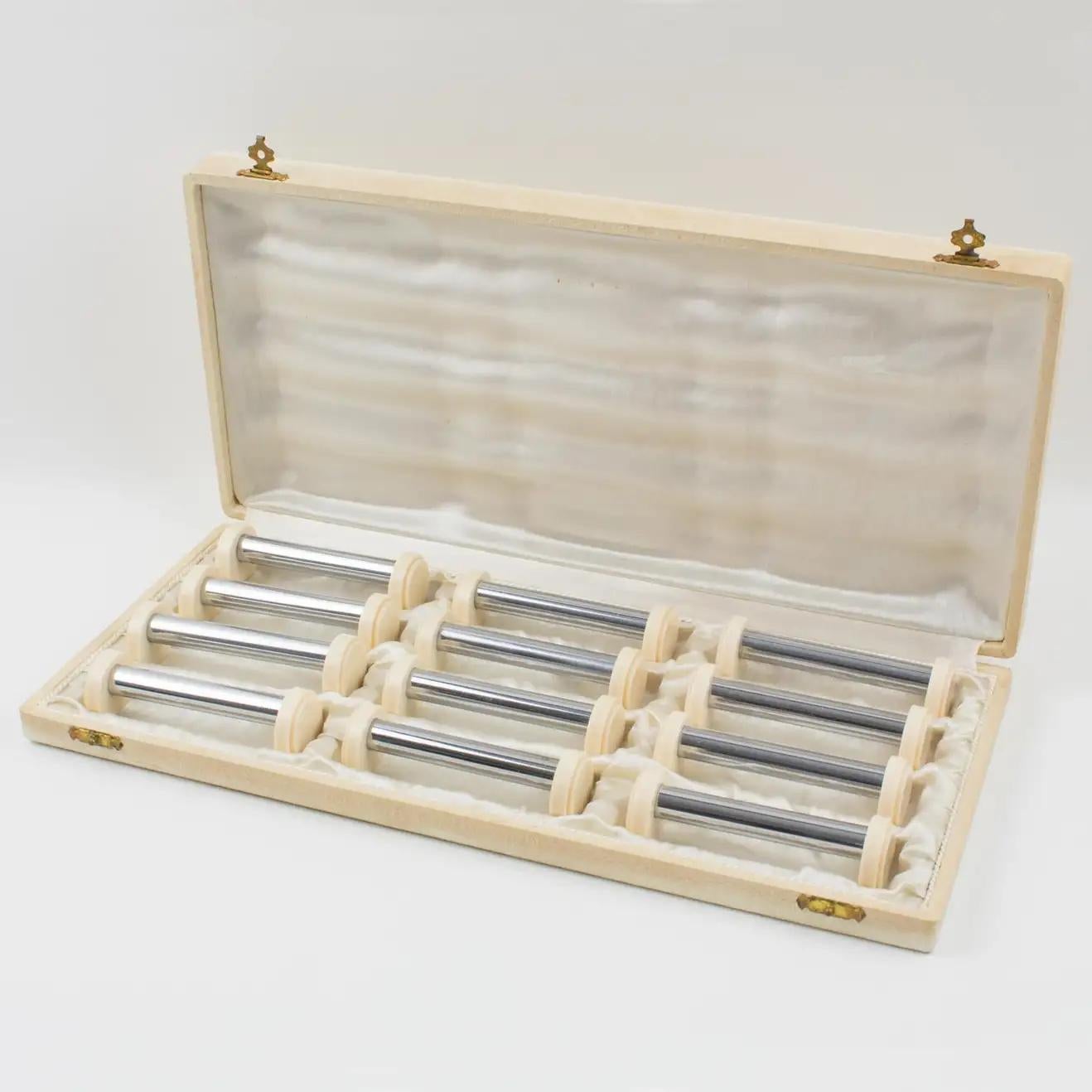 This lovely Art Deco set of twelve chrome and Galalith knife or chopstick rests was crafted in France in the 1930s. They feature a modernist shape with a long chromed metal stick bar and geometric side holders in off-white Galalith with a textured