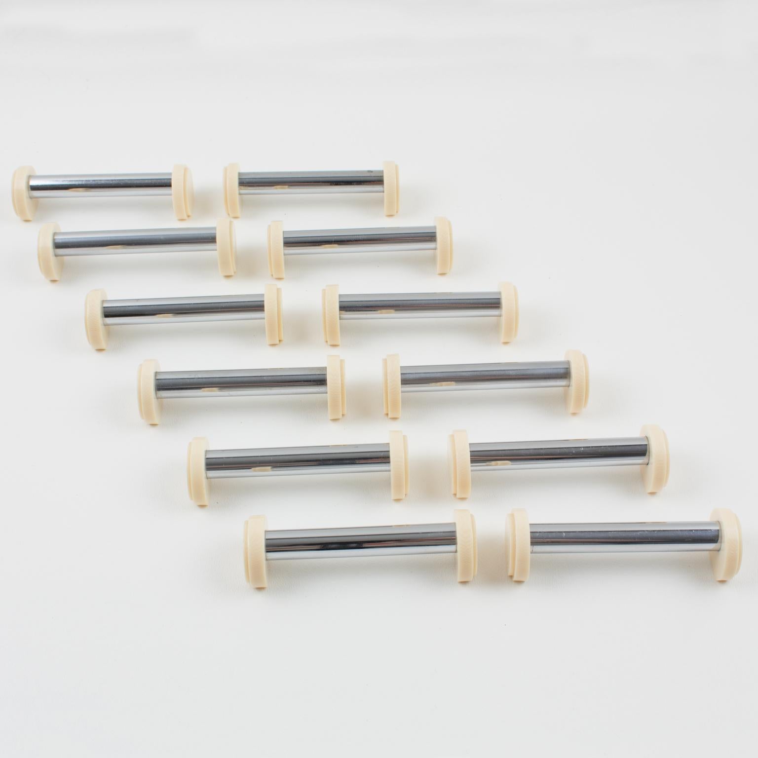 This stunning Art Deco set of twelve chrome and Galalith knife or chopstick rests was crafted in France circa 1930. Each piece features a modernist shape with a long, chromed metal stick bar and geometric side holders in off-white Galalith, accented