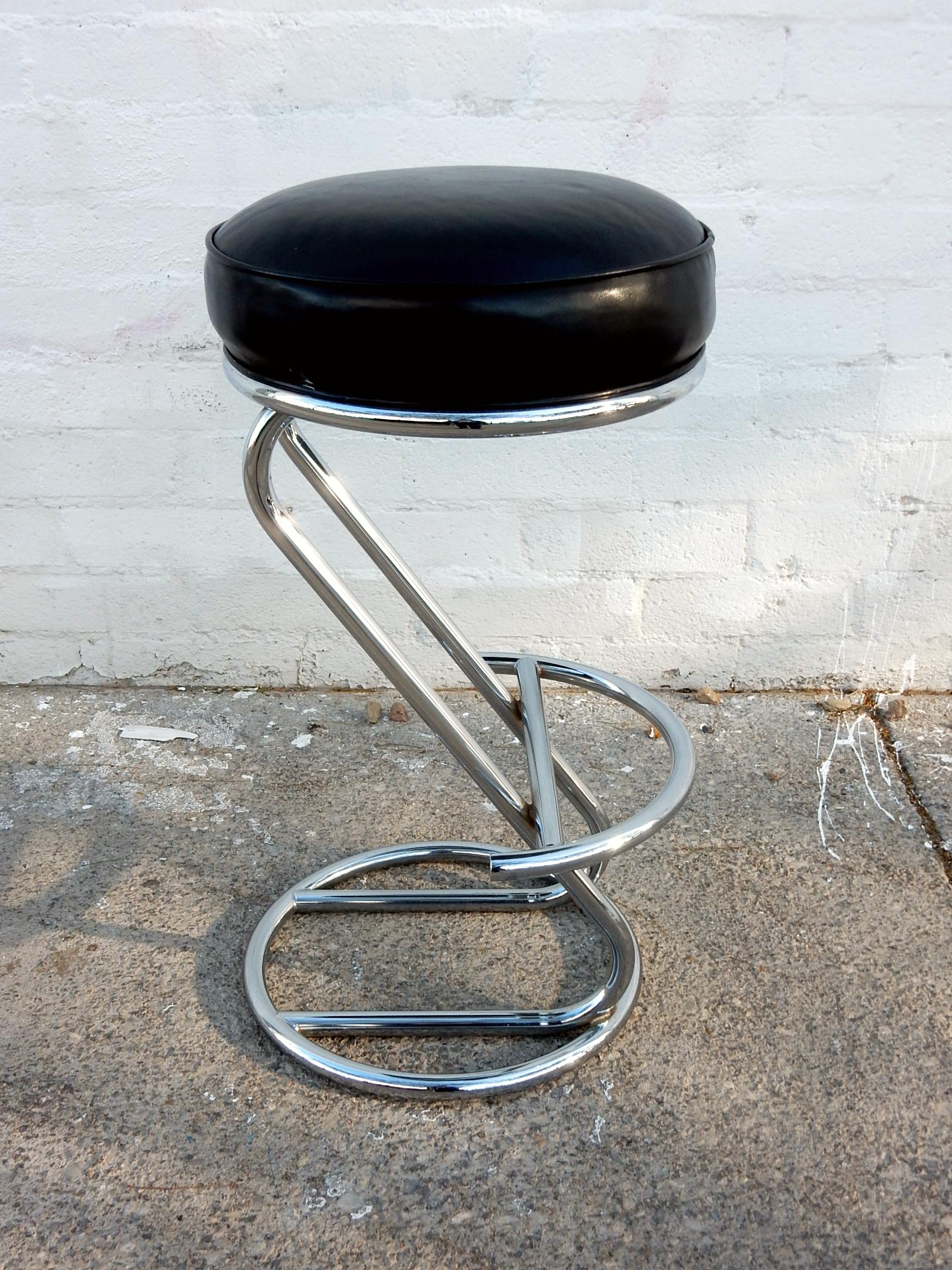 Tall, plush, leather bar stools from the 1960s.
Sculpted of steel tubing with triple chrome plating.
Muffin top seating area consisting of premium black leather with memory foam.
Heavy solid and very comfortable.
32 inch to top of cushion.