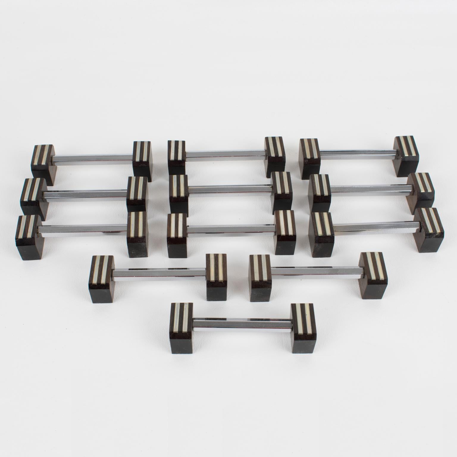 This elegant Art Deco set of twelve pieces in chrome and Macassar wood knife or chopstick rests was crafted in France in the 1930s. The modernist shape boasts a hexagonal metal stick bar and geometric carved wood sides. There is no visible maker's
