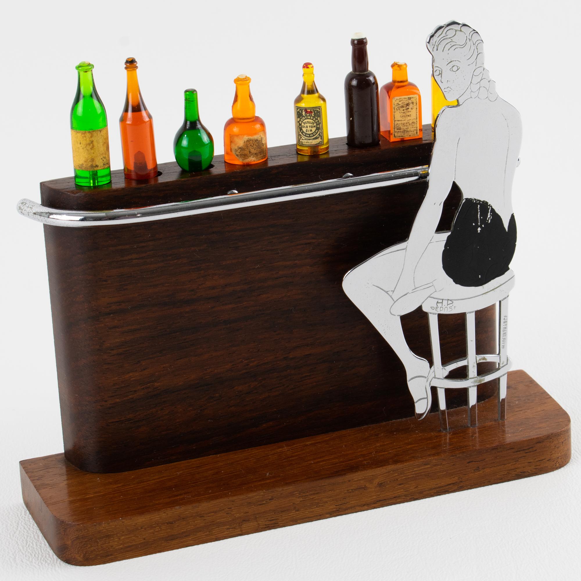 Atemberaubendes Art Deco Cocktail Picks Ensemble mit Bar aus Makassarholz und Damenfigur - Frankreich, um 1930.
Erweitern Sie Ihre private Sammlung mit diesem exquisiten Art-Déco-Cocktail-Pick-Set, das um 1930 in Frankreich von der renommierten