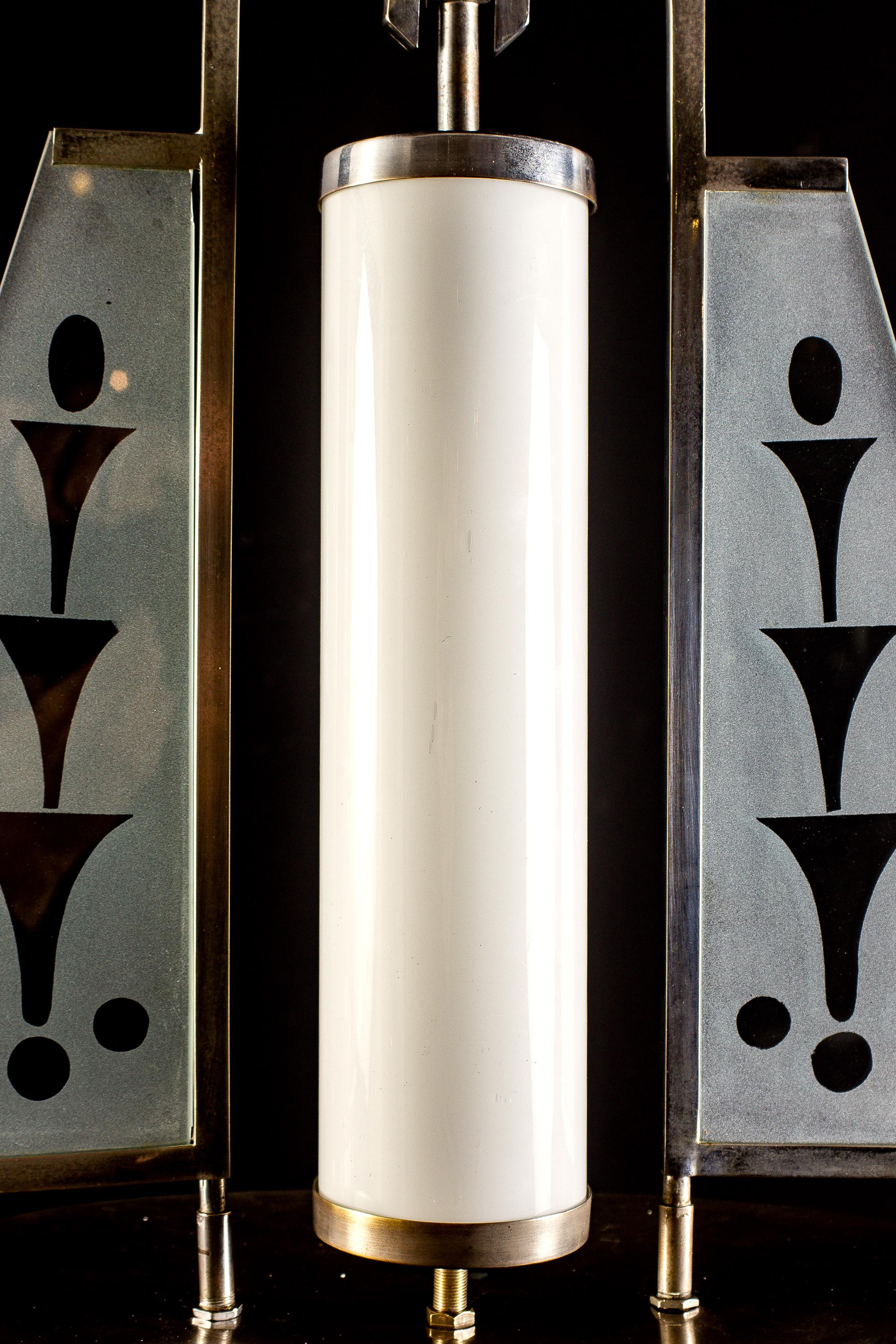 Curious and rare design Fontana Arte attributed pendant with in chromium plated frame attributed to Pietro Chiesa studio. 
Two glass satin finished panels decorated with fountains centered by opaque glass tubes. 
Gio Ponti and Pietro Chiesa were