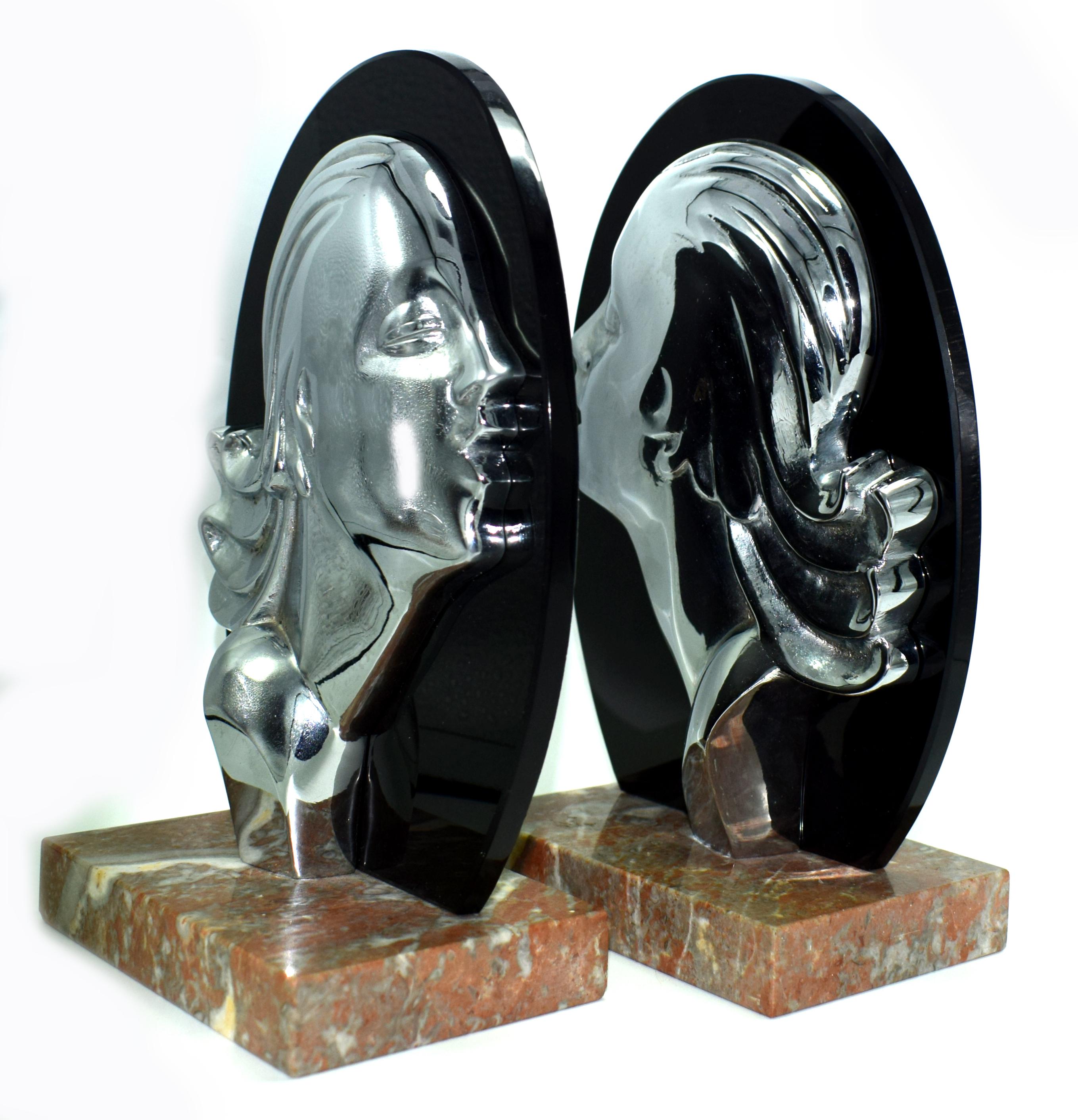 Striking pair of Art Deco bookends, very weighty, superb quality and look amazing. The backing is jet black vitrolite (compressed glass) which acts as the back drop to a chrome stylised Art Deco ladies profile. The base is solid marble and as such