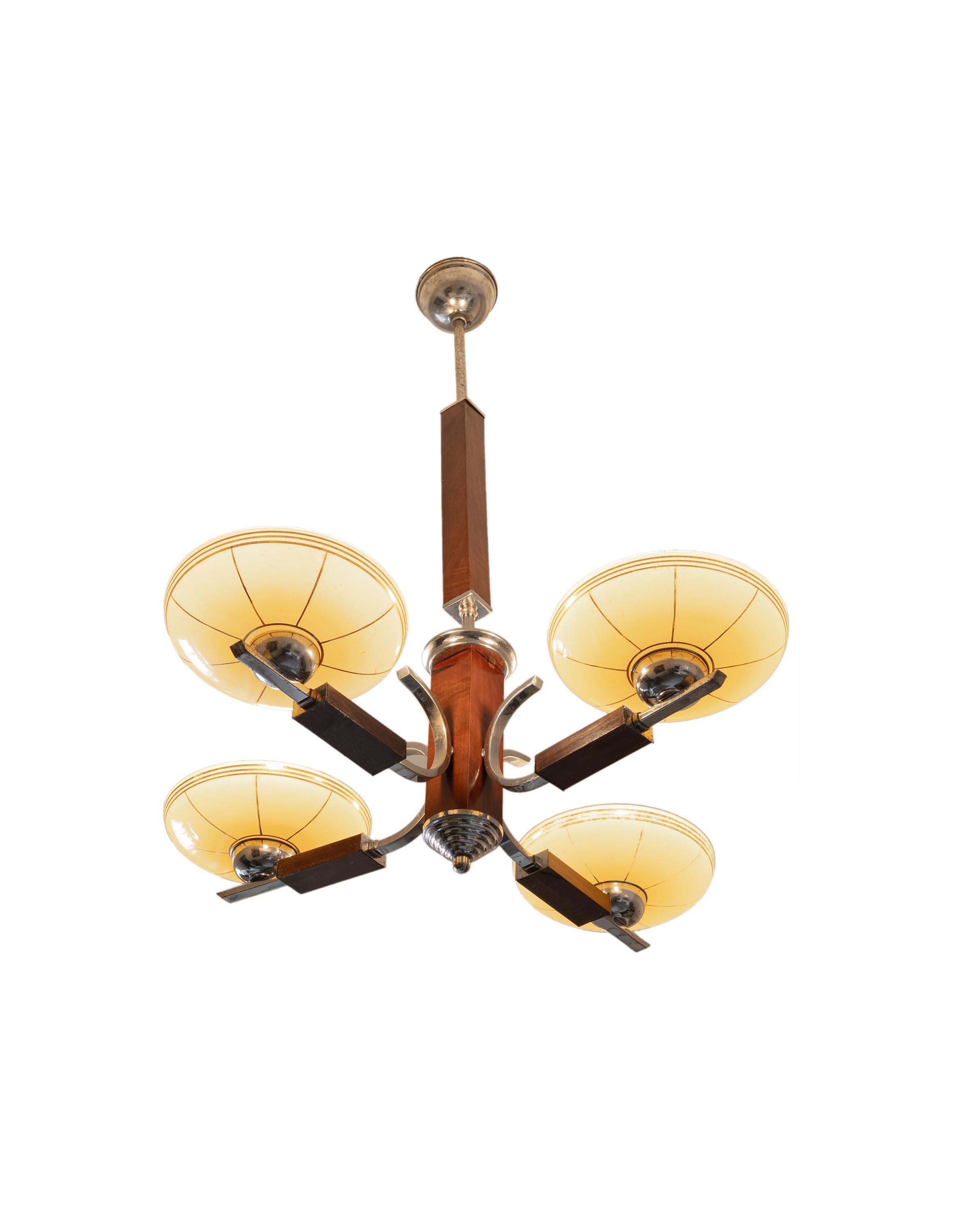 This captivating Art Deco ceiling lamp from Czechoslovakia, crafted in the 1930s, embodies the elegance and geometric forms of the Art Deco era. With its four chrome arms and vibrant yellow shades, it will add a touch of glamour and sophistication