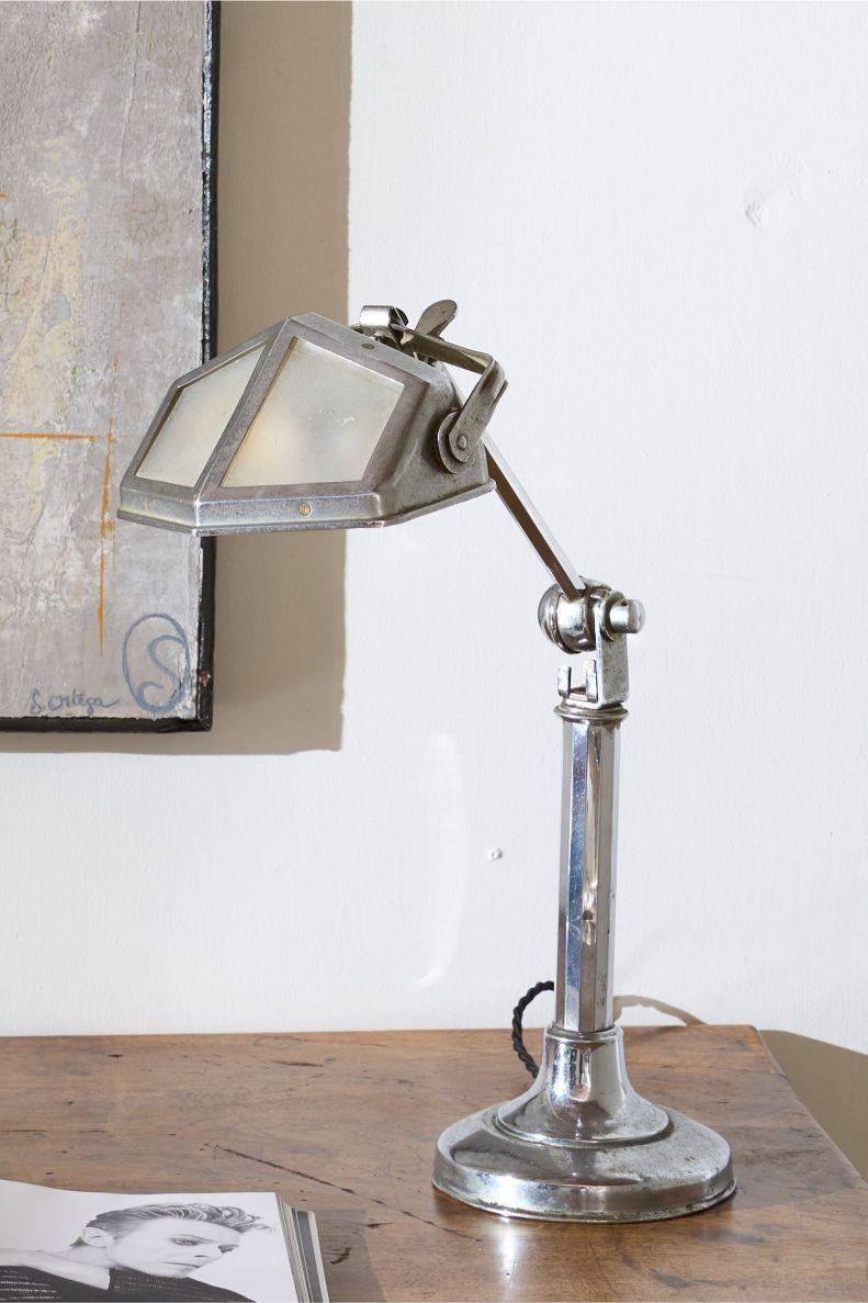 This is a very smart totally original, adjustable Art Deco desk lamp. The chrome has a lovely aged patina to it and this still retains the original frosted glass shade. The lamp is adjustable. It starts compact and then you can pull up the extending