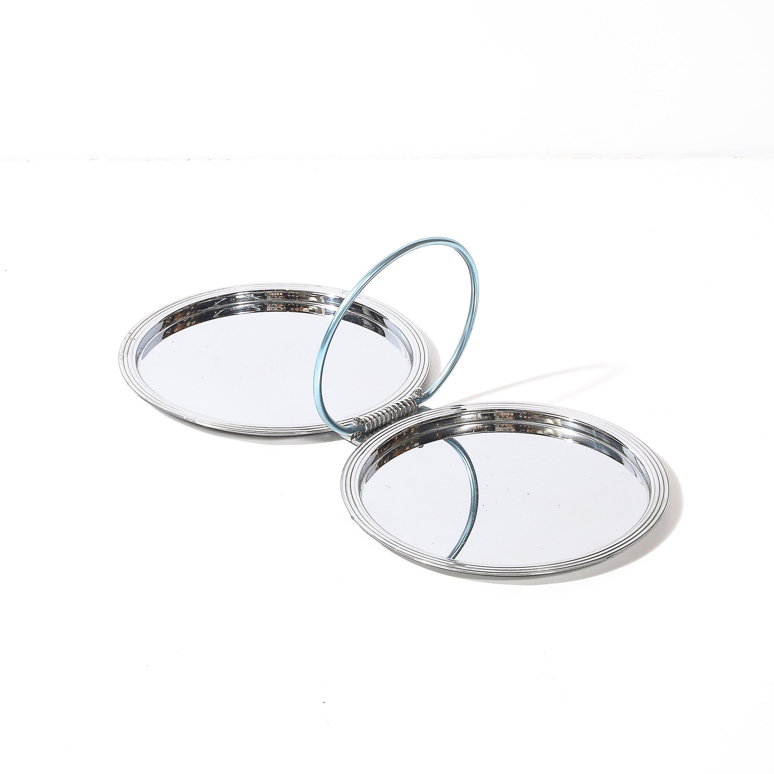 This striking Art Deco folding tray, crafted by Manning Bowman in America circa 1935, is an enduring example of the Machine Age's innovative design and modernist aesthetics. Signed by the renowned American manufacturer known for its high-quality