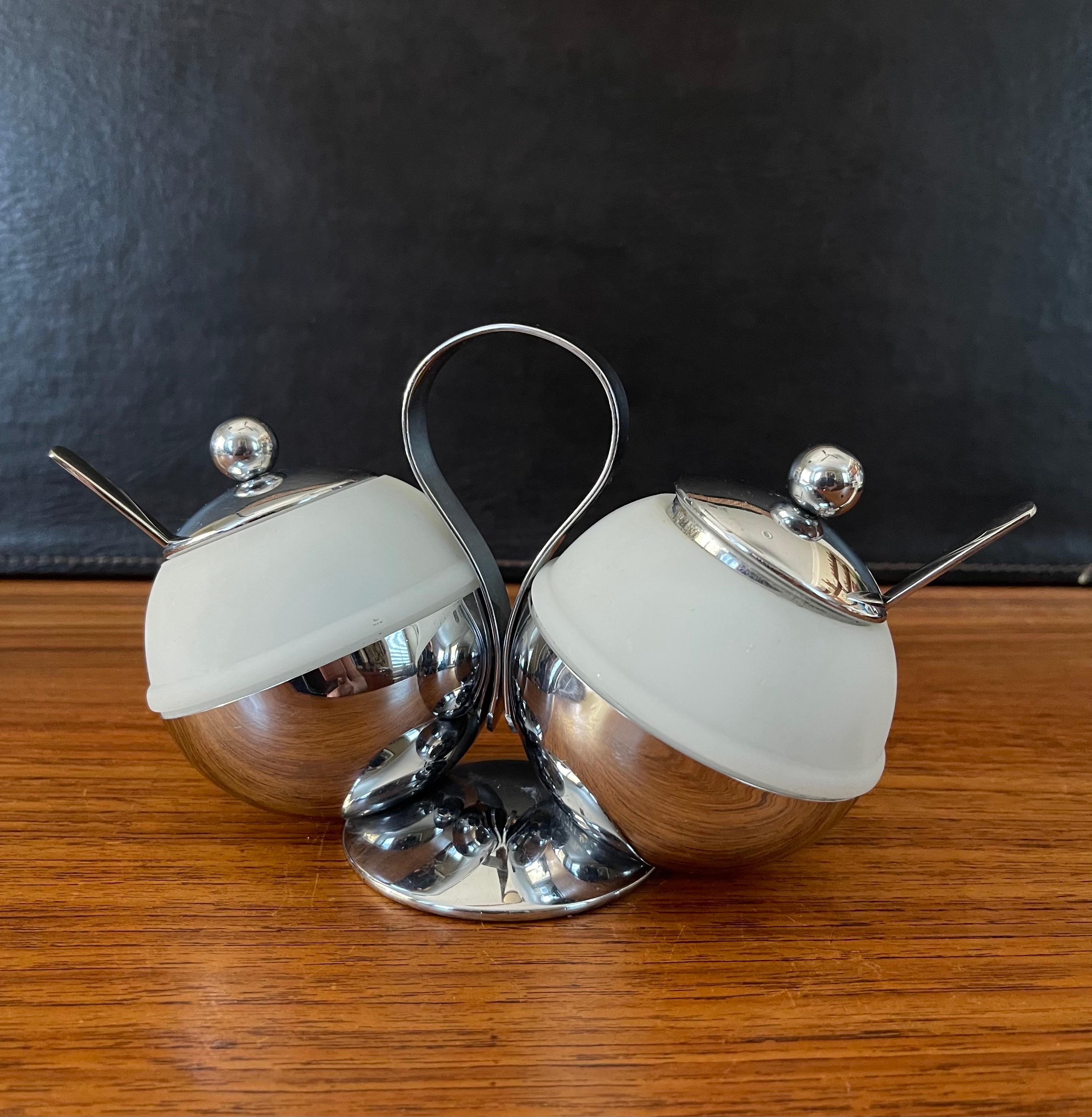 Art Deco chrome & white glass double condiment server with spoons by Chase & Co., circa 1930s. The piece is in very good to excellent vintage condition and measures 6.5