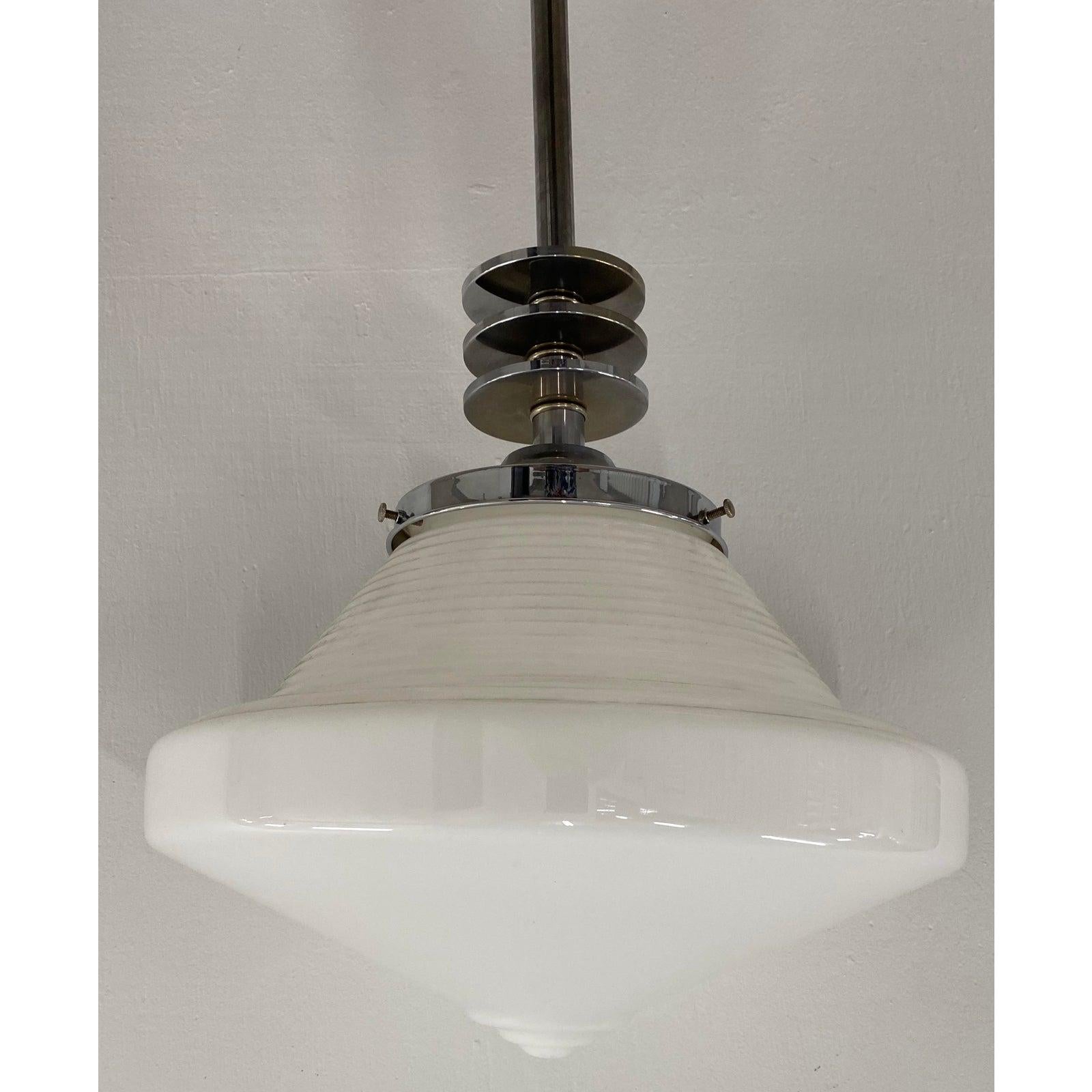 Art Deco chrome & glass pendant light, circa 1930s

A Classic Deco pendant chandelier that will look great in any room of your home. From the game room to the dining room. A great vintage find!

The shade is 14