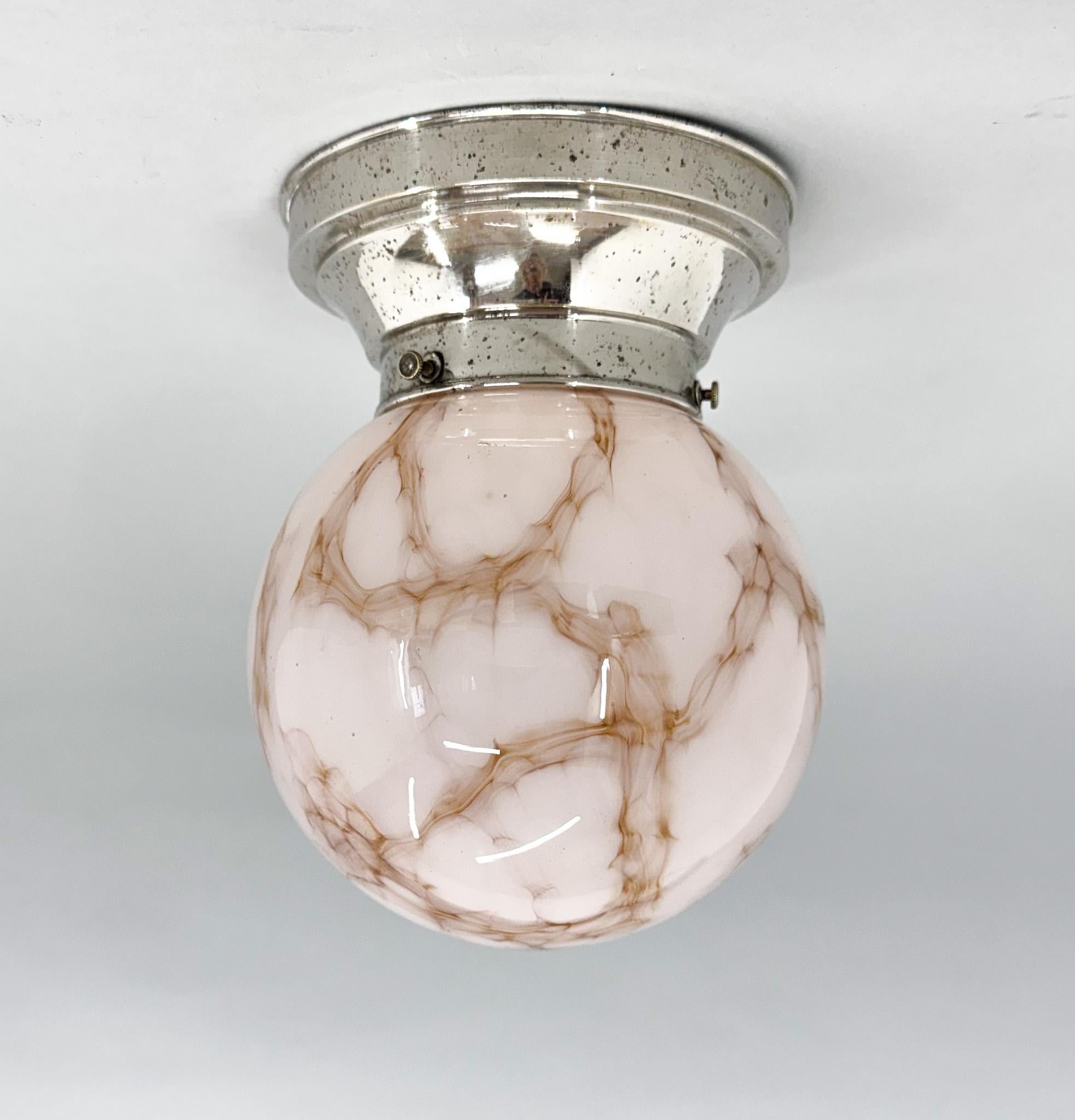 Art Deco ceiling lamp with chrome-plated metal base and beautiful marble glass shade. The chrome part shows some signs of wear and tear from time, but otherwise the lamp is in good condition. New wiring. Compatible with American cable. New wiring.