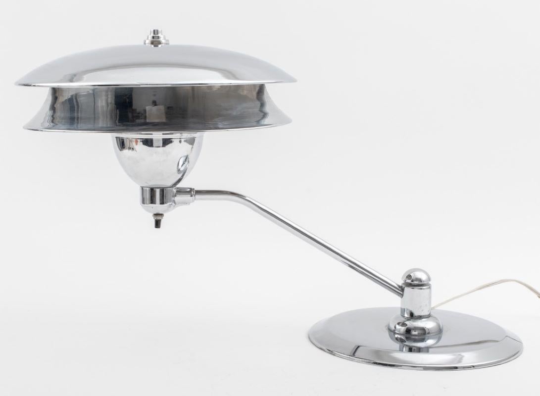 Art Deco chromed metal table or desk lamp with an extended arm and tiered chrome shade and finial. 16