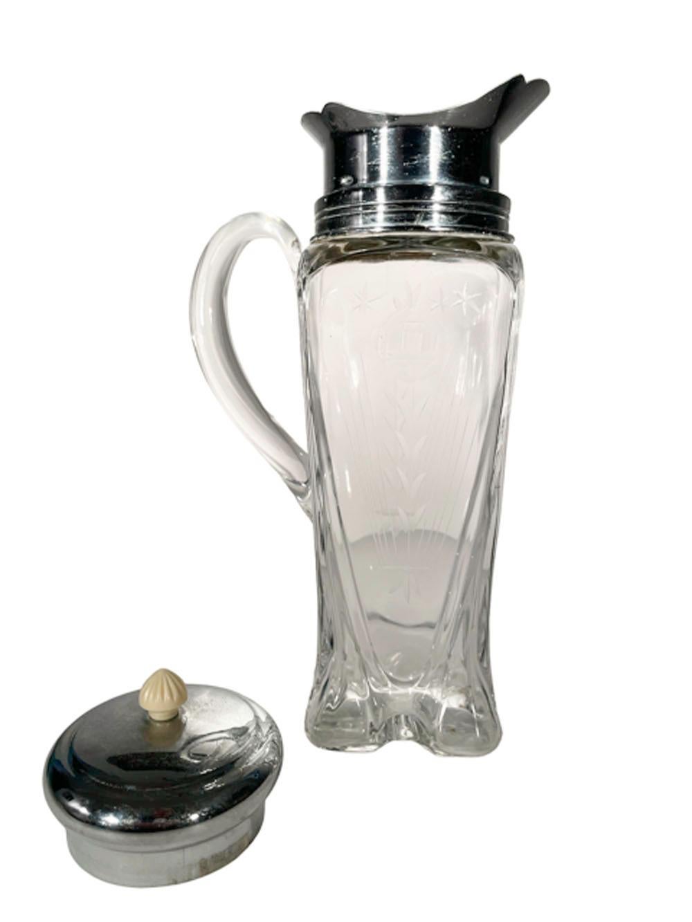 Art Deco cocktail shaker / pitcher by Cambridge Glass of square form with molded feet and etched side panel with an applied handle. Mounted with a chrome pour spout with removable ice dam and lid with a white Bakelite finial. 