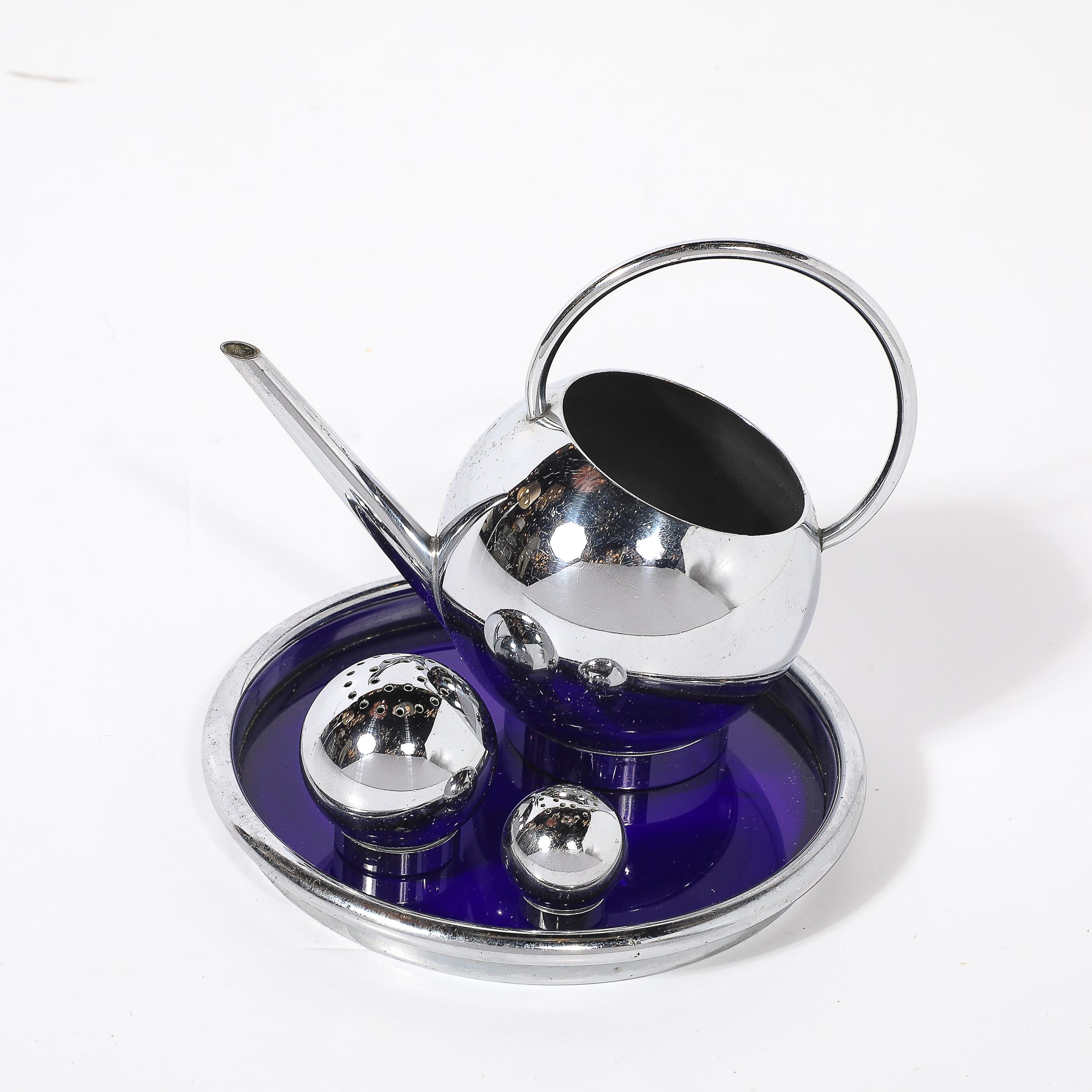 Designed by the iconic American industrial designer Russel Wright for Chase, this Art Deco pancake corn set epitomizes the streamlined and functional aesthetic of the 1930s. The set includes polished chrome serving pieces displayed on a striking