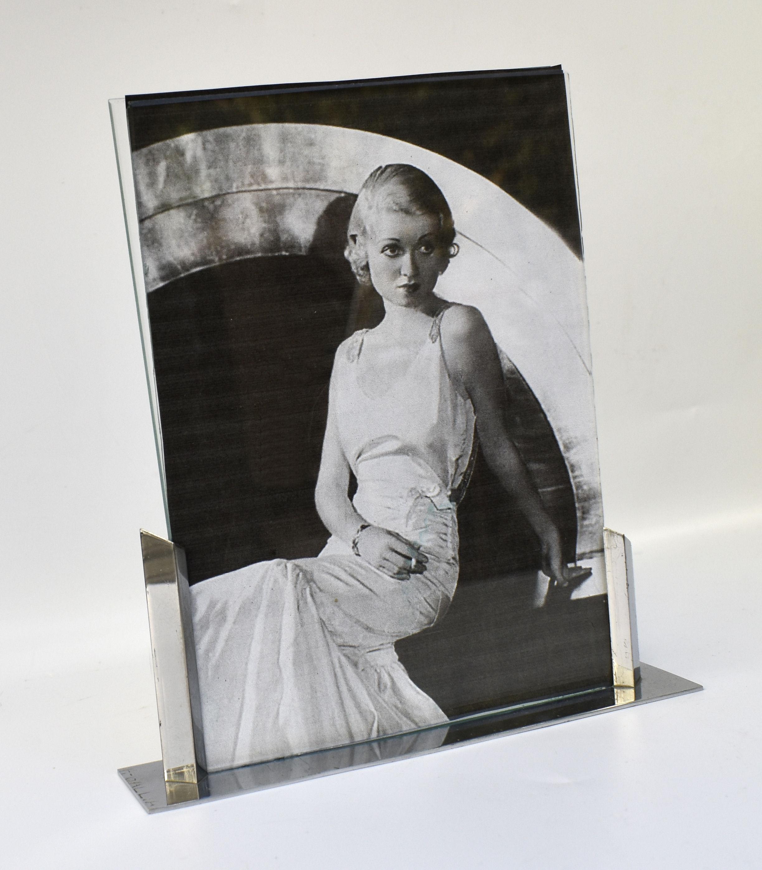 Super stylish 1930's Art Deco Modernist picture frame in chrome and glass. Signed to the base f. Gallia, The frame has two pieces of glass which slot into the chrome Stand allows an image to be displayed both sides of the free standing frame. Ideal