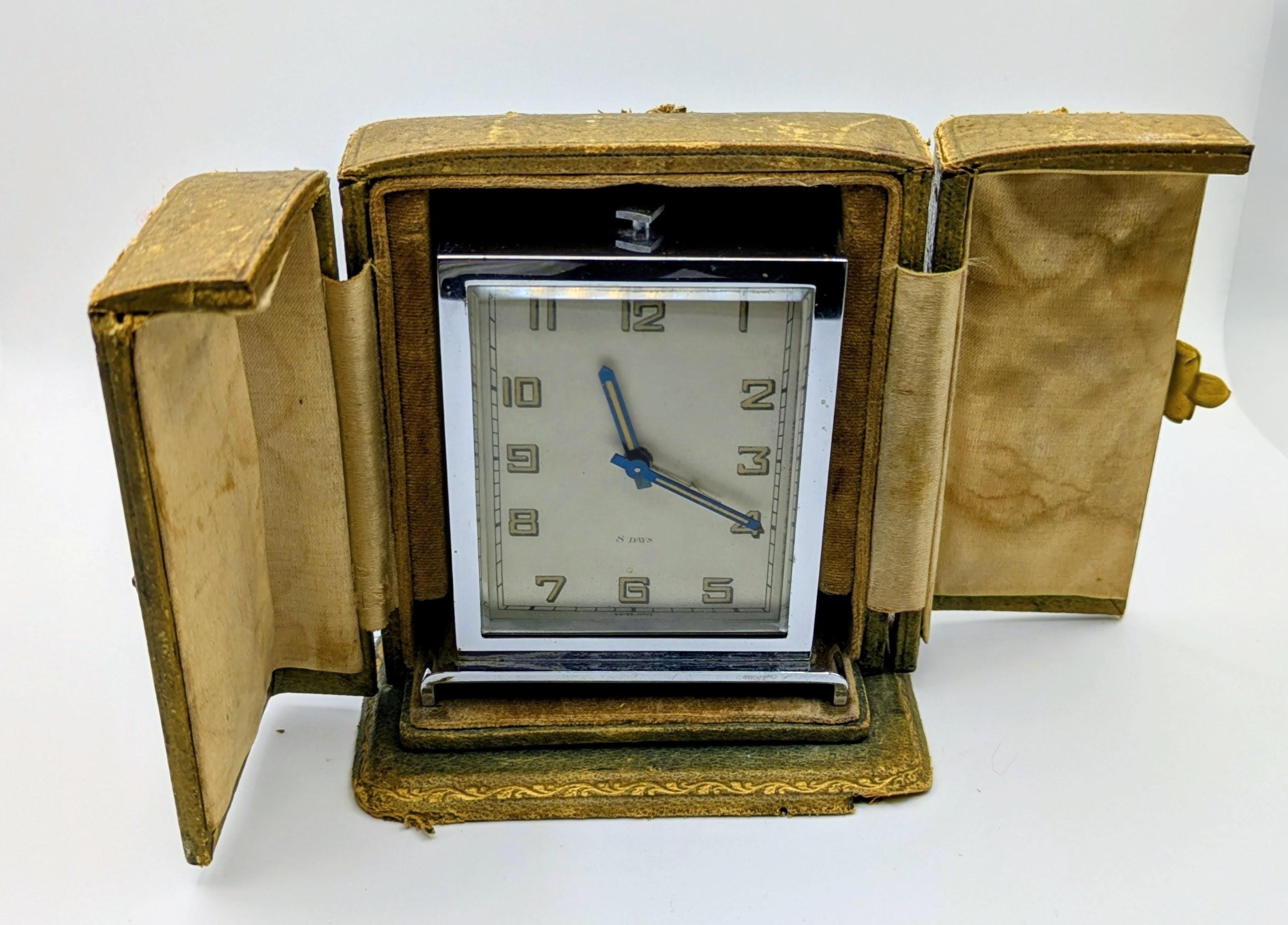 This elegant Art Deco travel clock, crafted for Harrods of London in the 1930s, is a superb example of early 20th-century design. The clock features a striking chrome-plated case with clean geometric lines characteristic of the Art Deco movement,