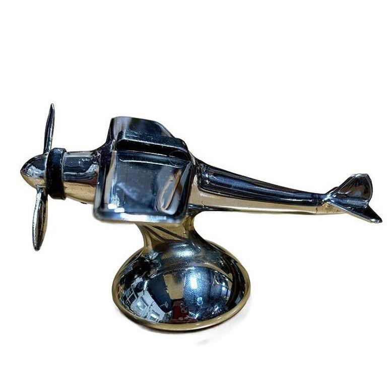 Art Deco style chrome propeller airplane table butane lighter by Hamilton, when the propeller is turned the black lighter lid pops up and the fire is started .

Stamped- 