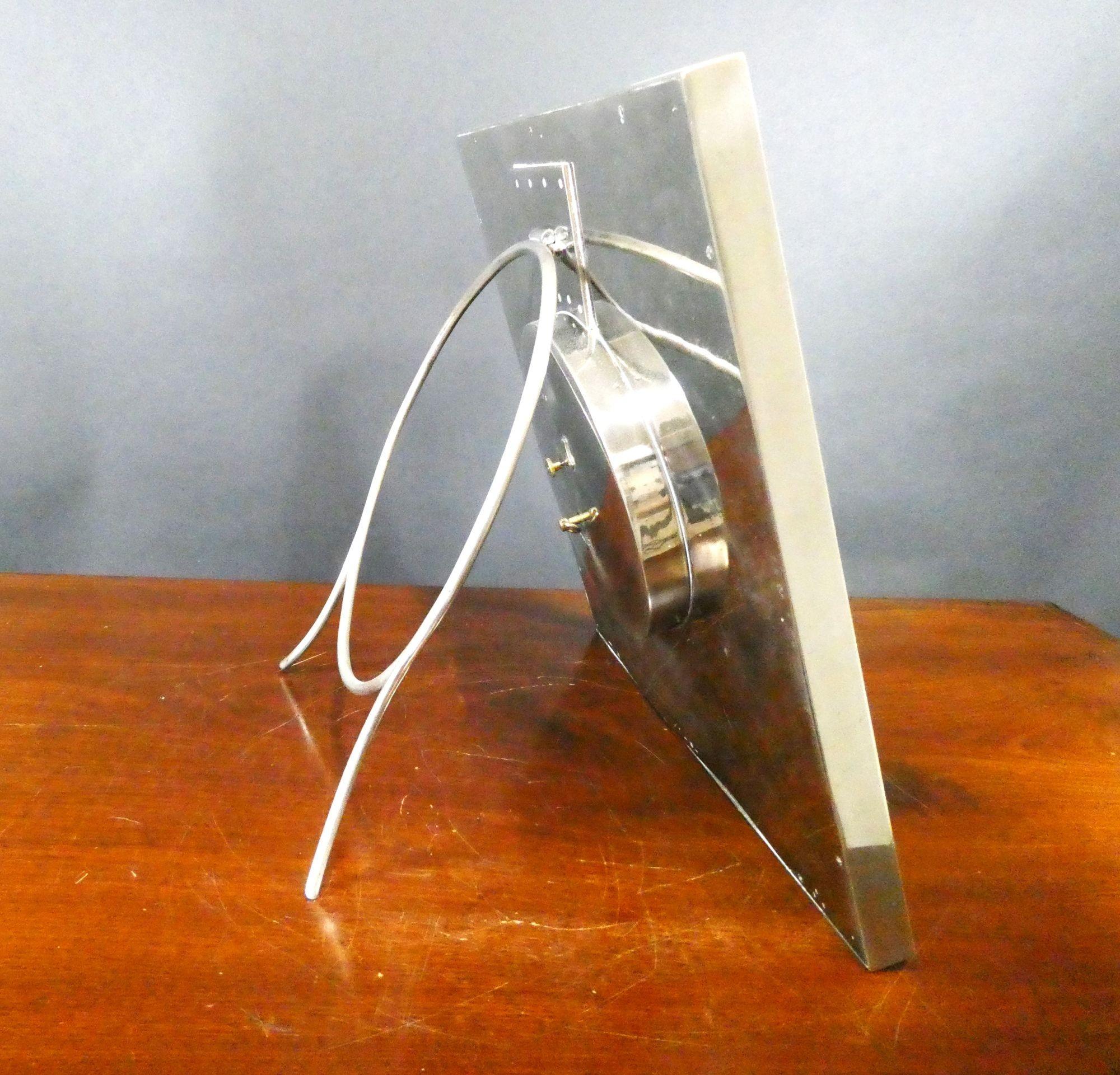 Large Art Deco chrome strut clock, bevelled glass in front of the painted dial with Art Deco style numerals and original luminous hands signed ‘Finnigans, Paris, Eight Days’.
Eight day French movement c.1920
The house of Finnigans was a British