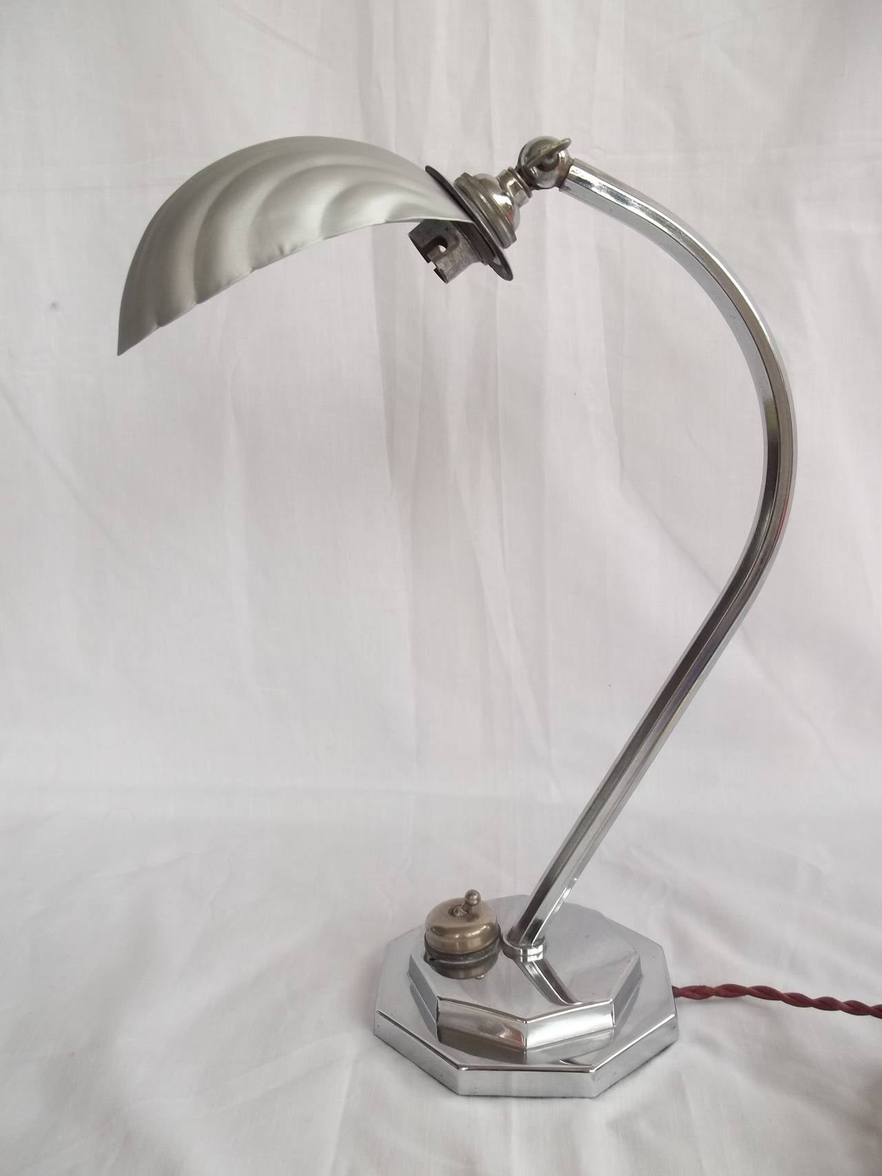 This is a very good and original desk or table lamp from the Art Deco period, circa 1920s

It is all original and has the classic geometric design features typified by the Art Deco period. 

The base has two chromed octagonal sections, one atop the