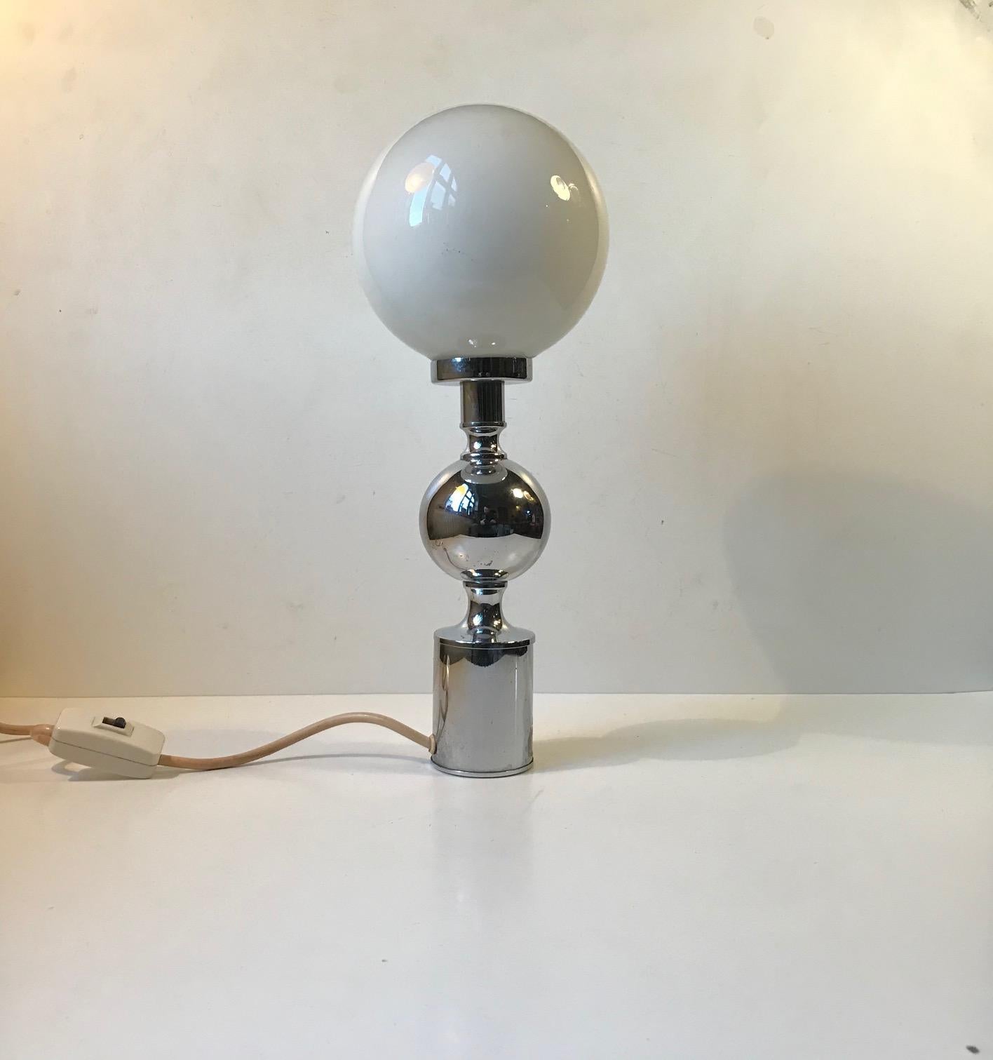 Sculptural chrome-plated table light with opaline glass sphere. Designed and manufactured by Sölken Leuchten in Germany during the 1970s.