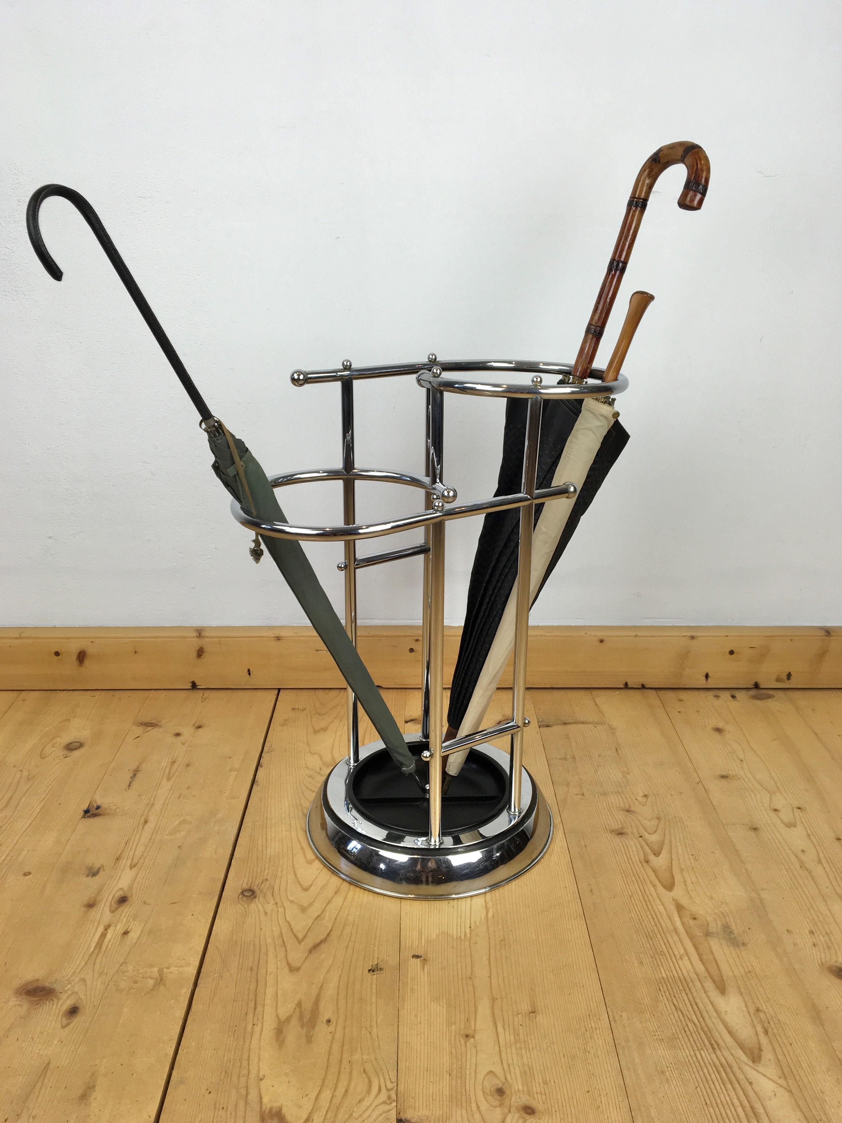 Chrome with bakelite umbrella stand by Demeyere Belgium. 
This Art Deco umbrella stand or umbrella holder has a beautiful rounded shape in Bauhaus Style. 
It has 2 sections: one left and one right to place the umbrellas. 
The chrome of this