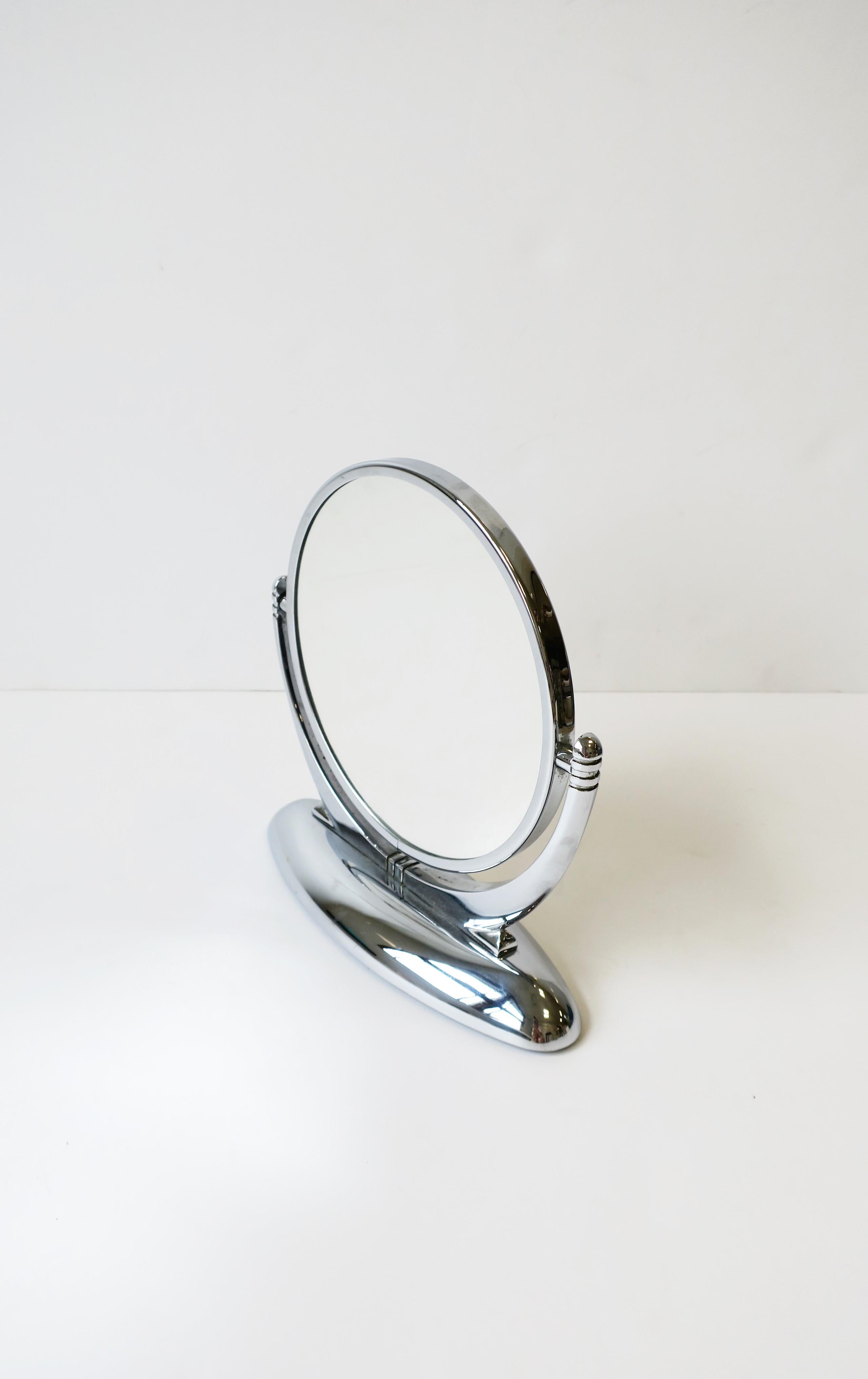 An Art Deco period two-sided chrome vanity table mirror, circa 1930s. One side is magnified. Mirror is substantial and well made. Measures: 8.5