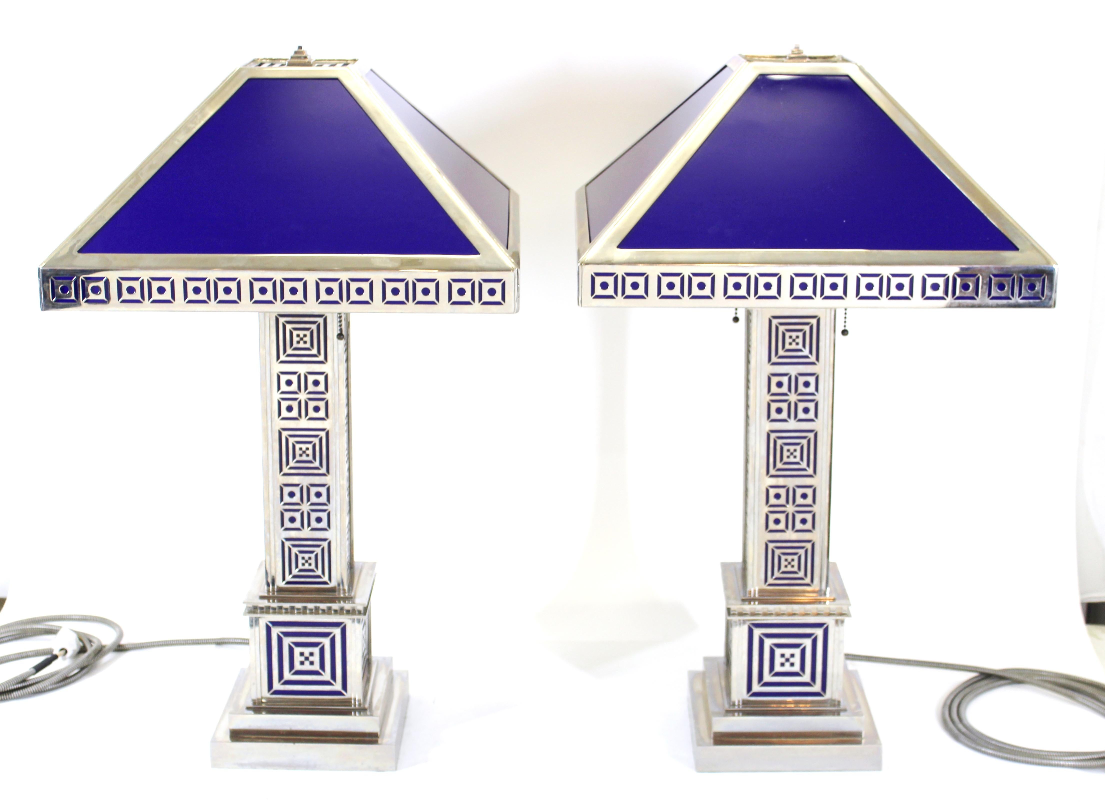 Art Deco pair of table lamps in chromed metal with modernist geometric latticework detailing and chromed metal shades with blue resin panels.