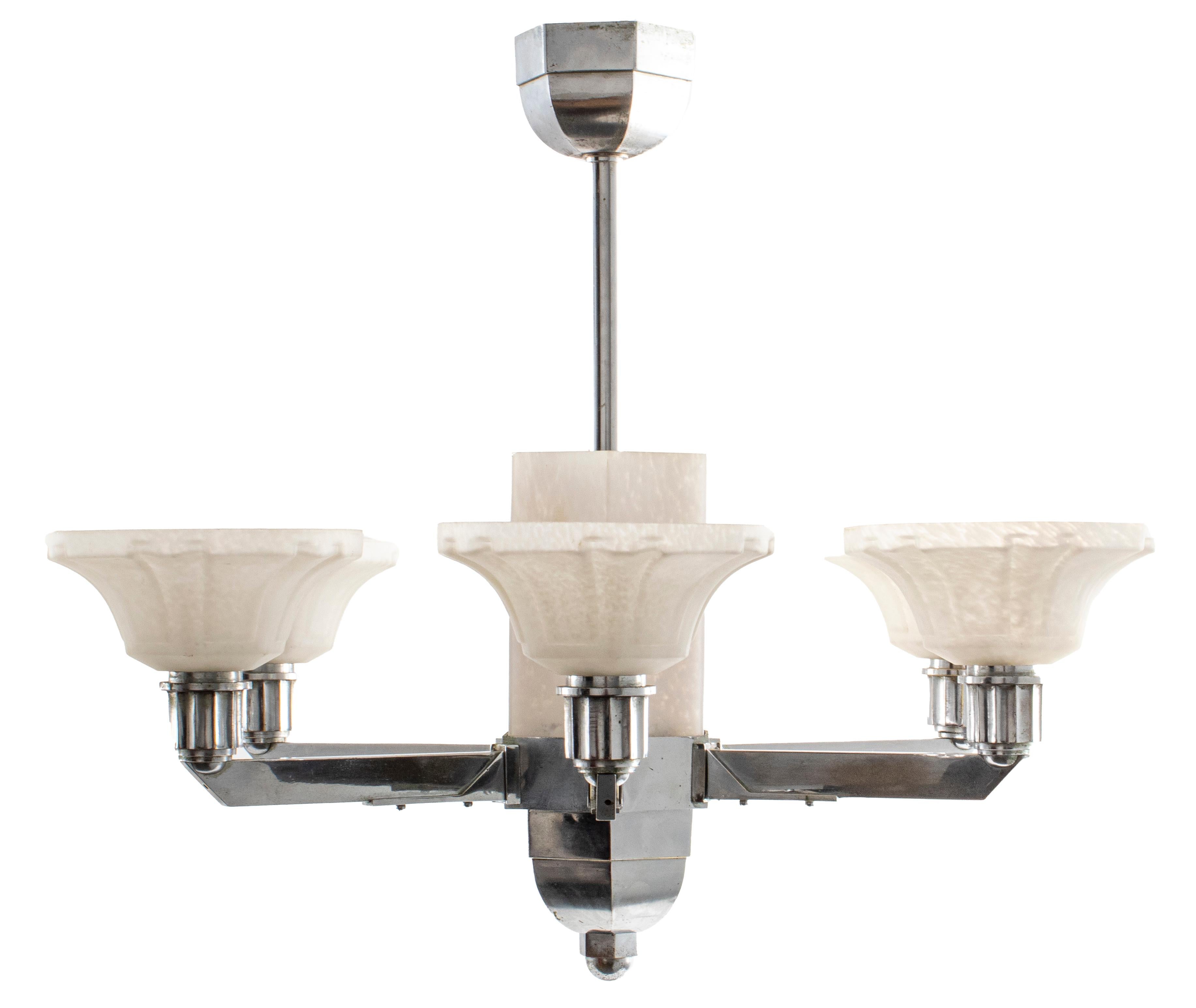 Art Deco chromed steel and frosted glass nine light chandelier, six arms around three central lights.

Dimensions: 16.5” Height x 21.5” diameter.

Dealer: S138XX.

 