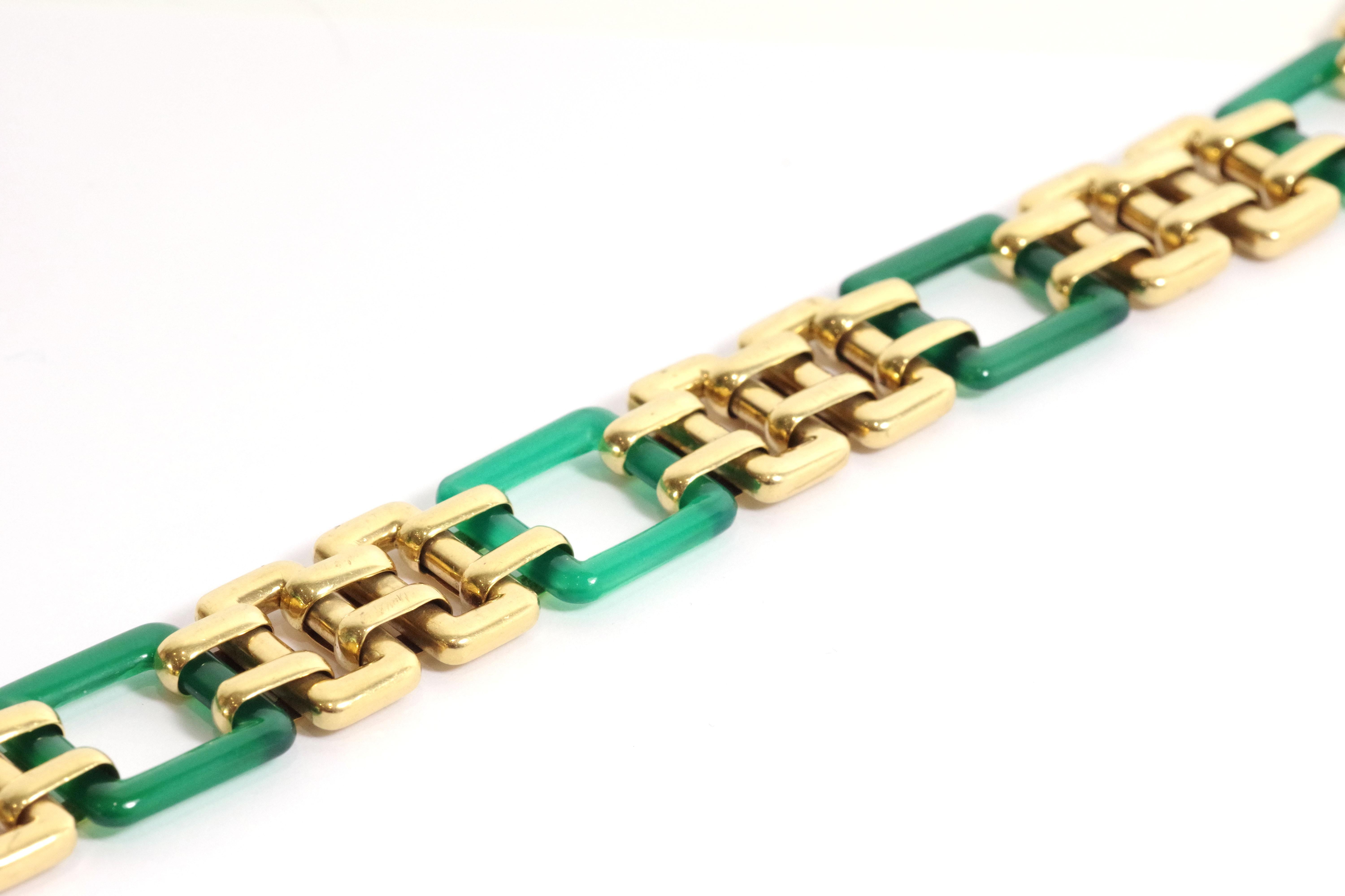 Art Deco square gold bracelet in 18 karats. Bracelet composed of seven alternating square links in gold and tinted green chalcedony (also called chrysoprase). French bracelet, Art Deco period, circa 1920-30. 

A similar model exists in the