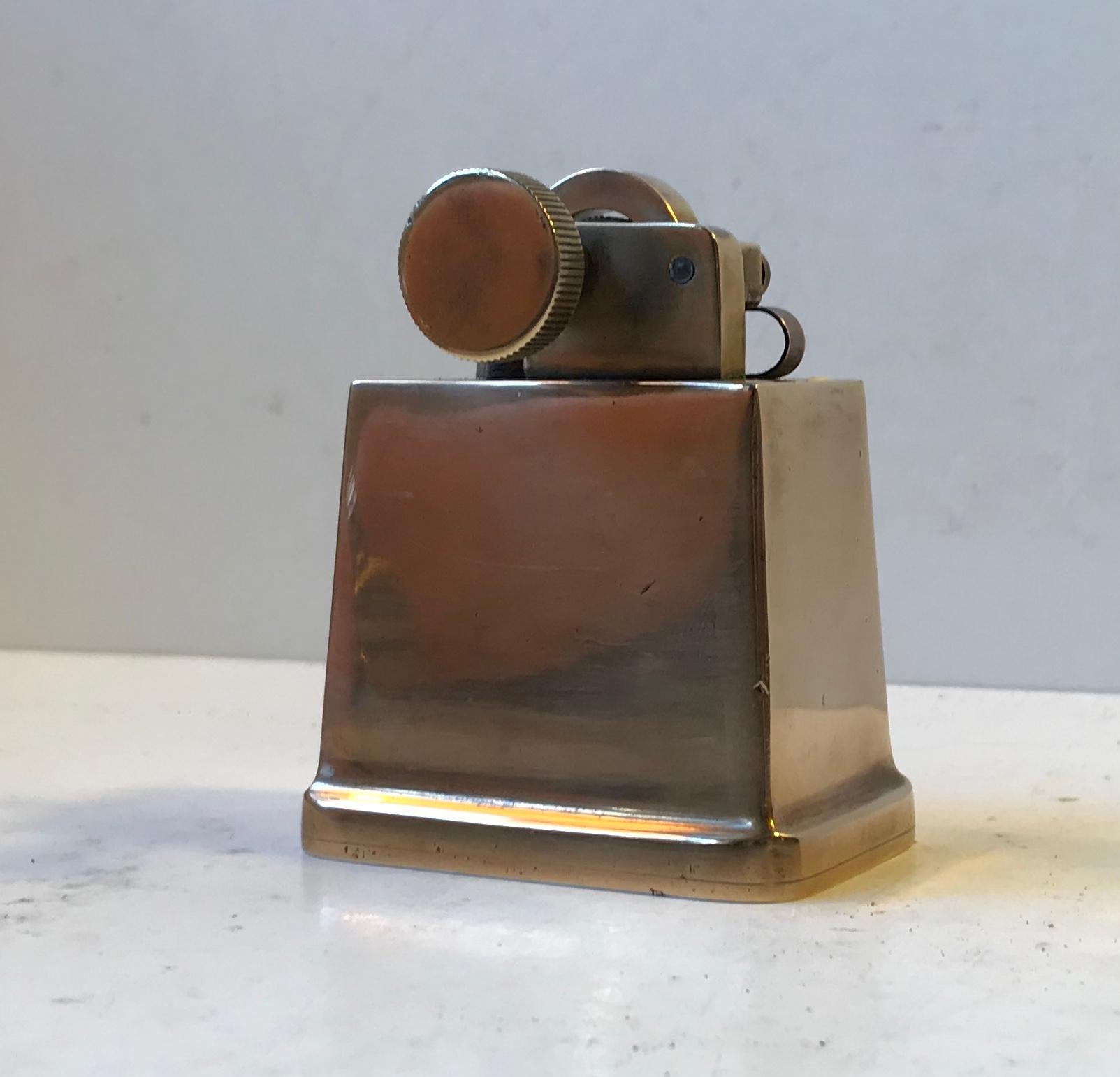 Literally built to last forever this mechanical paraffin table lighter by Tinos Denmark leaves no stones unturned. Very heavy solid bronze corpus, bronze liftarm and roll. It was made in the 1930s and the Art Deco styling is immense and