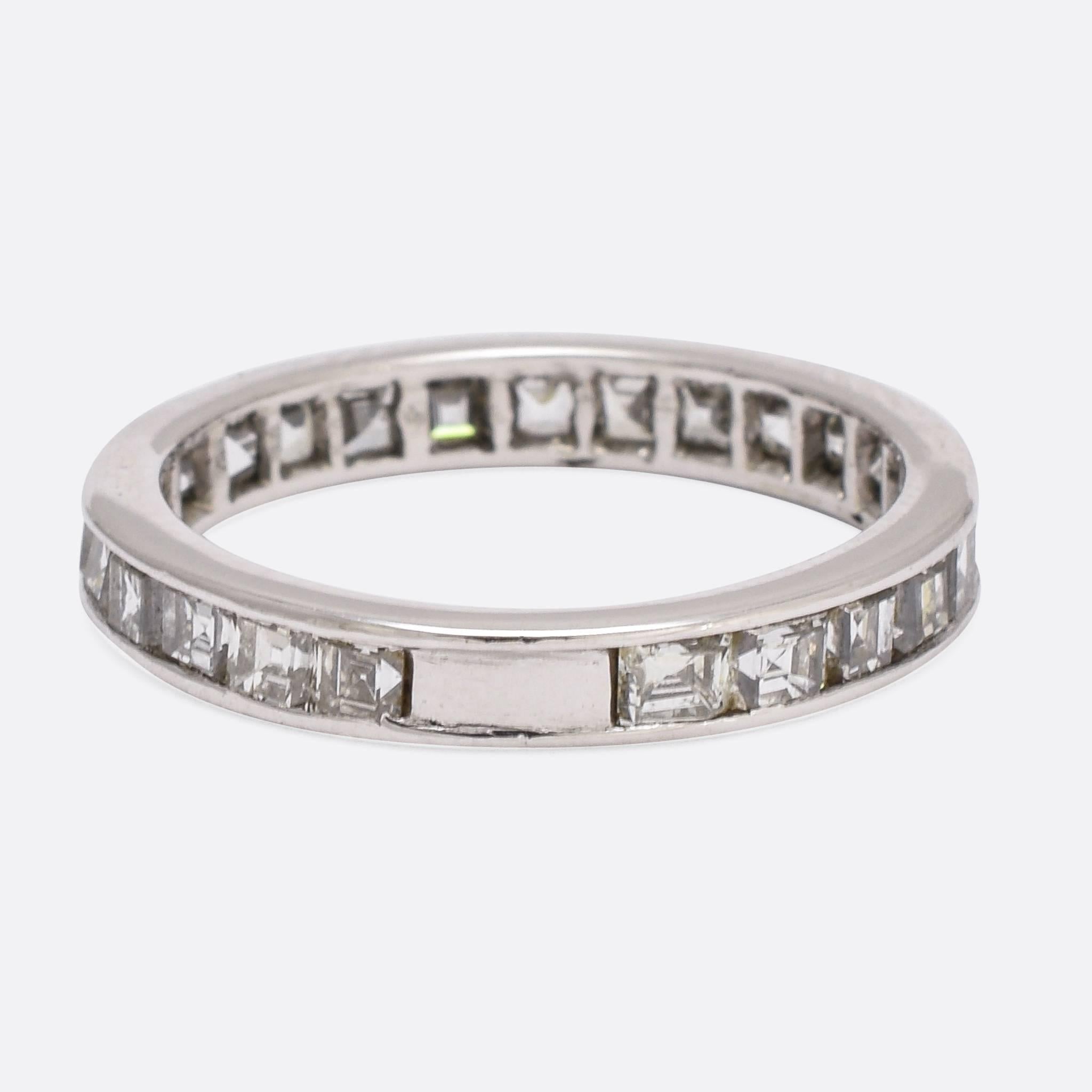 This exceptional vintage eternity ring is fully set with 25 carre cut diamonds, the weight totalling 2 carats. The ring is modelled in platinum throughout, and the deep stones are particularly clean and bright. An refined and timeless ring, unusual