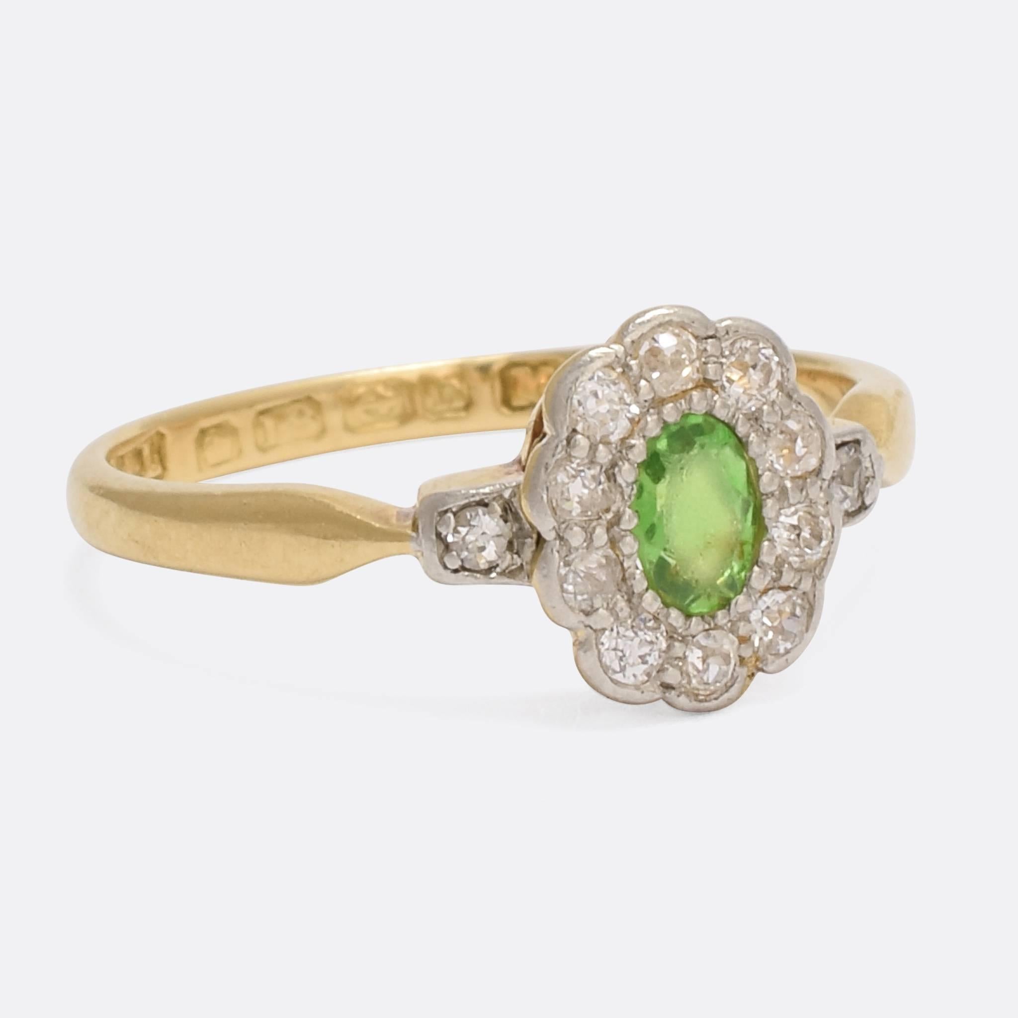 A pretty vintage flower cluster ring, set with a central Demantoid garnet (unusual to see in a ring of this style) and a halo of white diamond 
